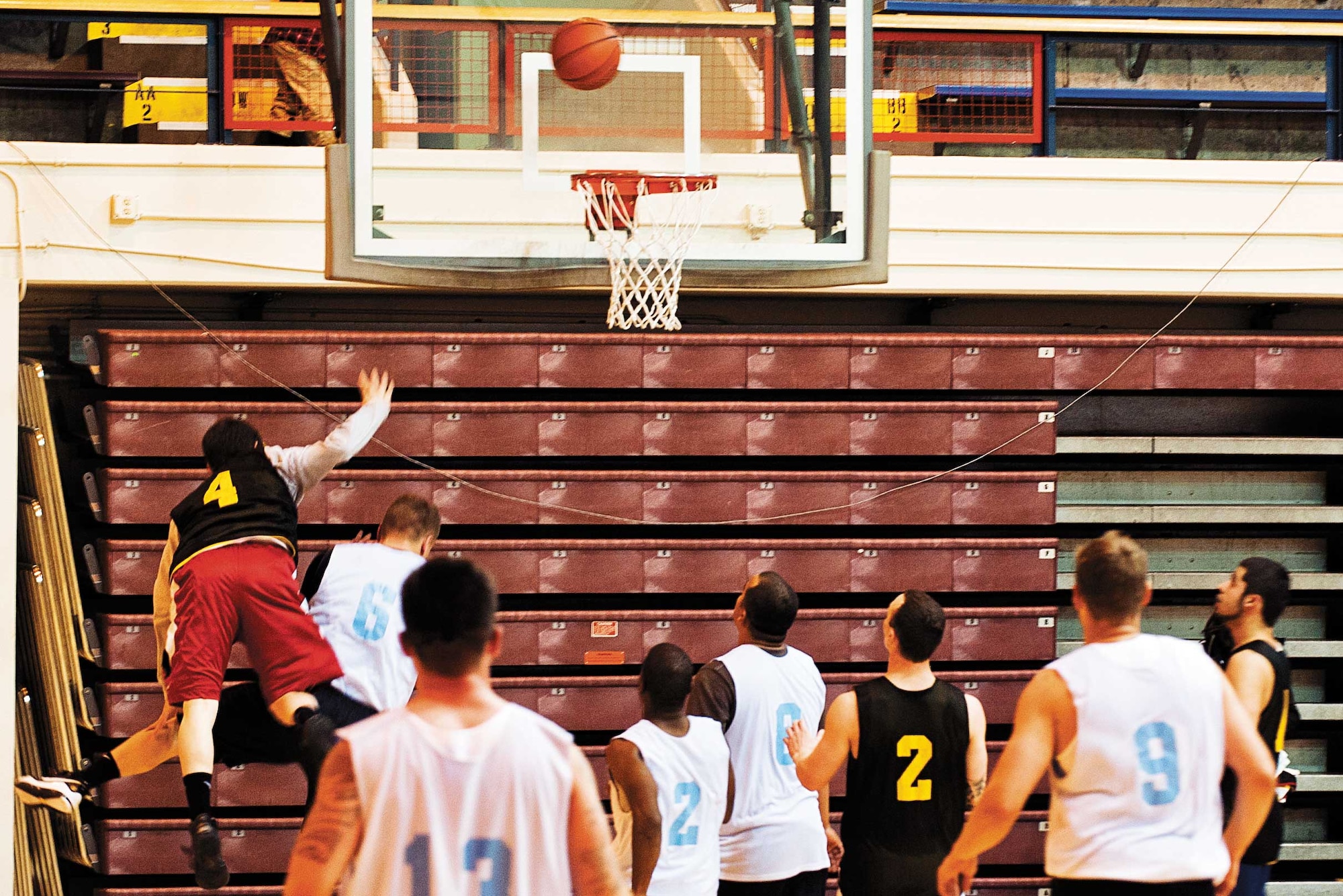 Anthony Urzi, military family member, shoots over a Soldier from B Company, 3rd Battalion, 509th Infantry Regiment during an intramural basketball game at Buckner Physical Fitness Center on Joint Base Elmendorf-Richardson Monday night. The players of A/725th BSB managed to beat out B/3-509th with a score of 68-53 in the run-up to the JBER playoffs. (U.S. Air Force photo/Staff Sgt . Zachary Wolf)