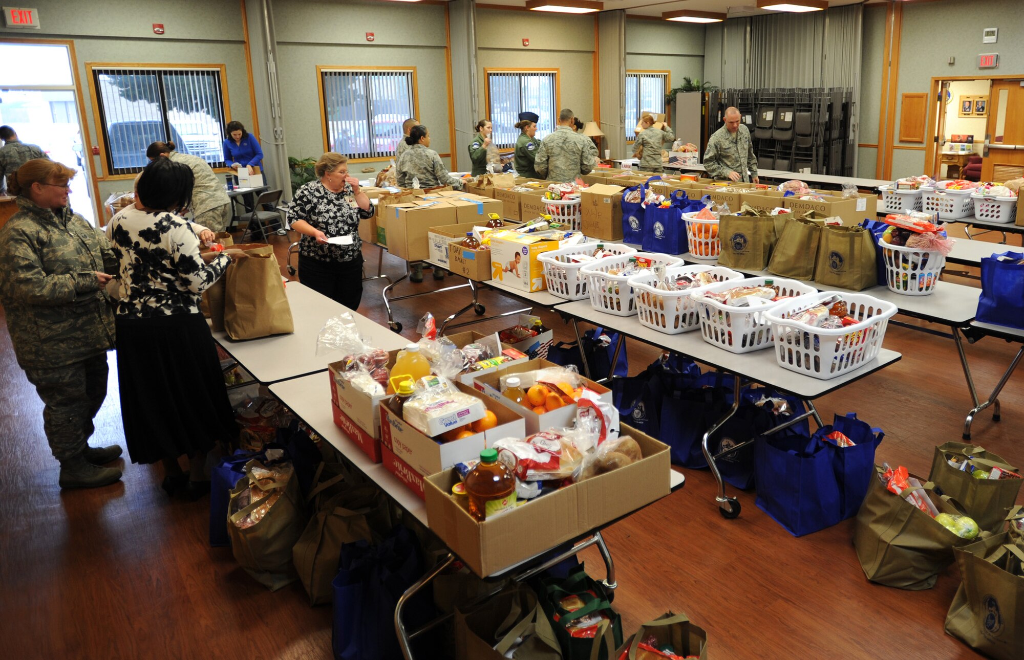 “Baskets” of groceries line tables in the chapel annex during the Thanksgiving Basket Giveaway Nov. 22, 2011, McConnell Air Force Base, Kan. Team McConnell Airmen and employees of the Airman and Family Readiness Center assembled 138 baskets for to McConnell Airmen. (U.S. Air Force photo/ Airman 1st Class Laura L. Valentine)