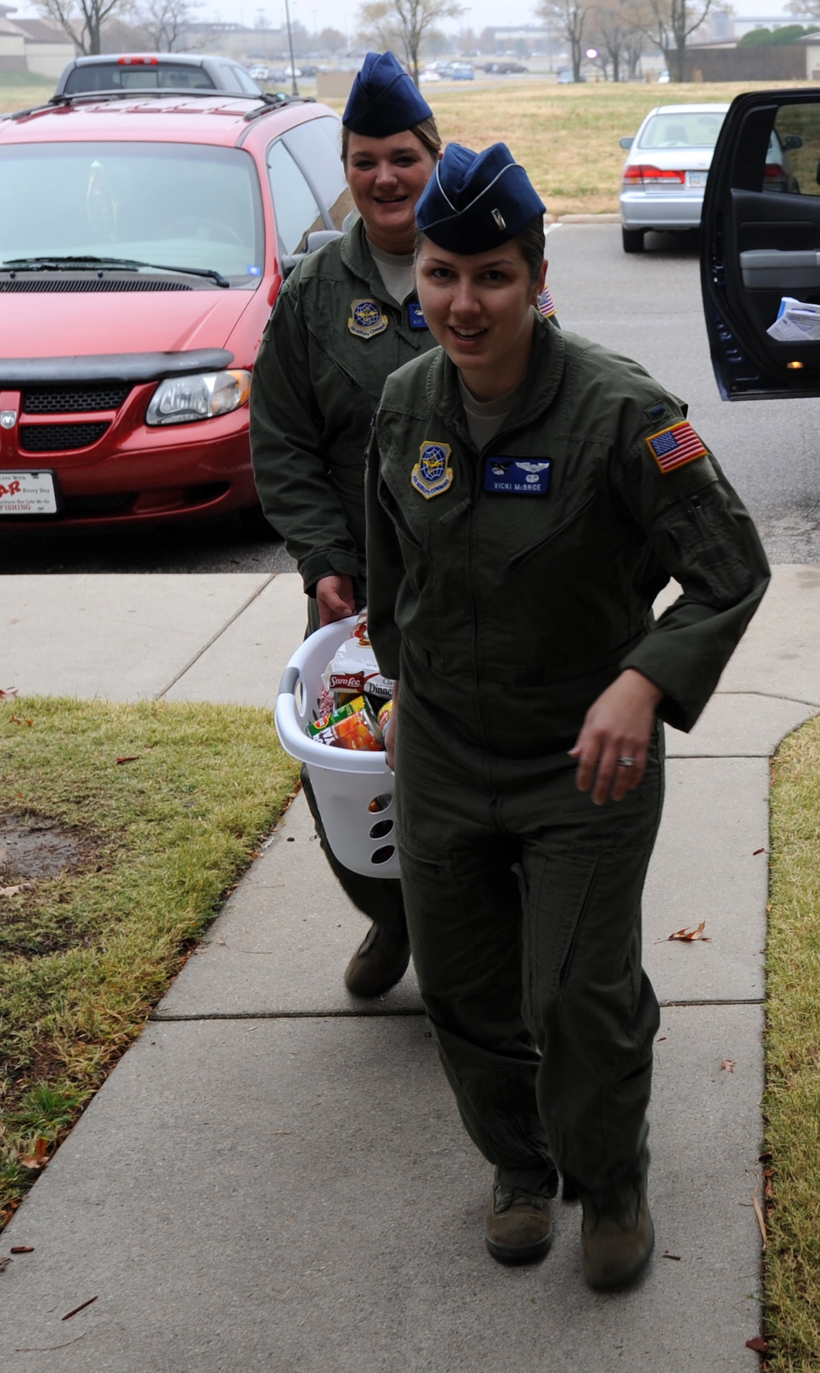 First Lt. Victoria McBride, 344th Air Refueling Squadron co-pilot, and Airman 1st Class Ashley Roames, 344th ARS boom operator, carry groceries for the Thanksgiving Basket Giveaway Nov. 22, 2011, McConnell Air Force Base, Kan. The 344th ARS was among several squadrons and units to donate “baskets” of food for Team McConnell Airmen. (U.S. Air Force photo/ Airman 1st Class Laura L. Valentine)