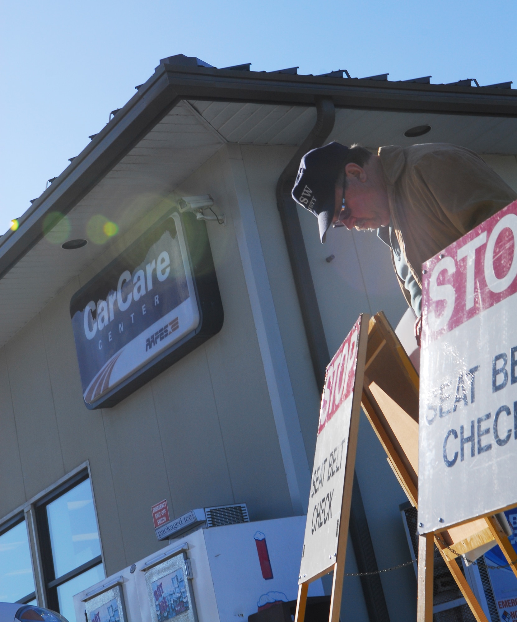 VANDENBERG AIR FORCE BASE, Calif. – Setting the stage for a vehicle safety check inspection, Mark Stortecky, with the 30th Space Wing Safety Office, places signage for a seat belt check at the Army and Air Force Exchange Service Car Care Center’s parking lot here at 9 a.m. Wednesday, Nov. 23, 2011. (U.S. Air Force photo/Senior Airman Steve Bauer)    