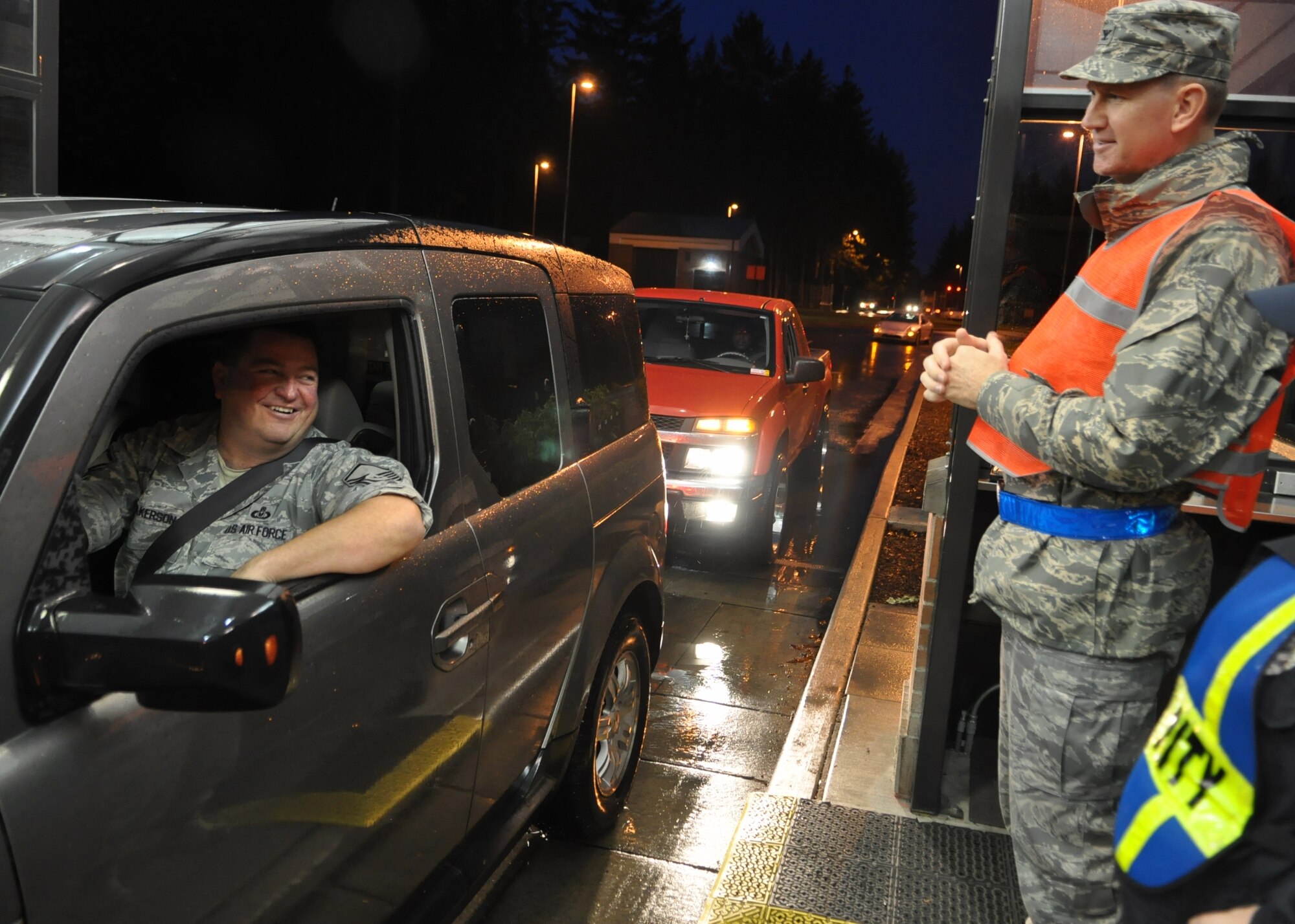 Col. Thomas Jackson, right, 62nd Maintenance Group commander, greets Airmen as they drive through the gate during the morning commute Nov. 23, 2011, at Joint Base Lewis-McChord, Wash. The leaders encouraged McChord Field personnel to have a safe and enjoyable holiday weekend. (U.S. Air Force photo/Airman 1st Class Leah Young)