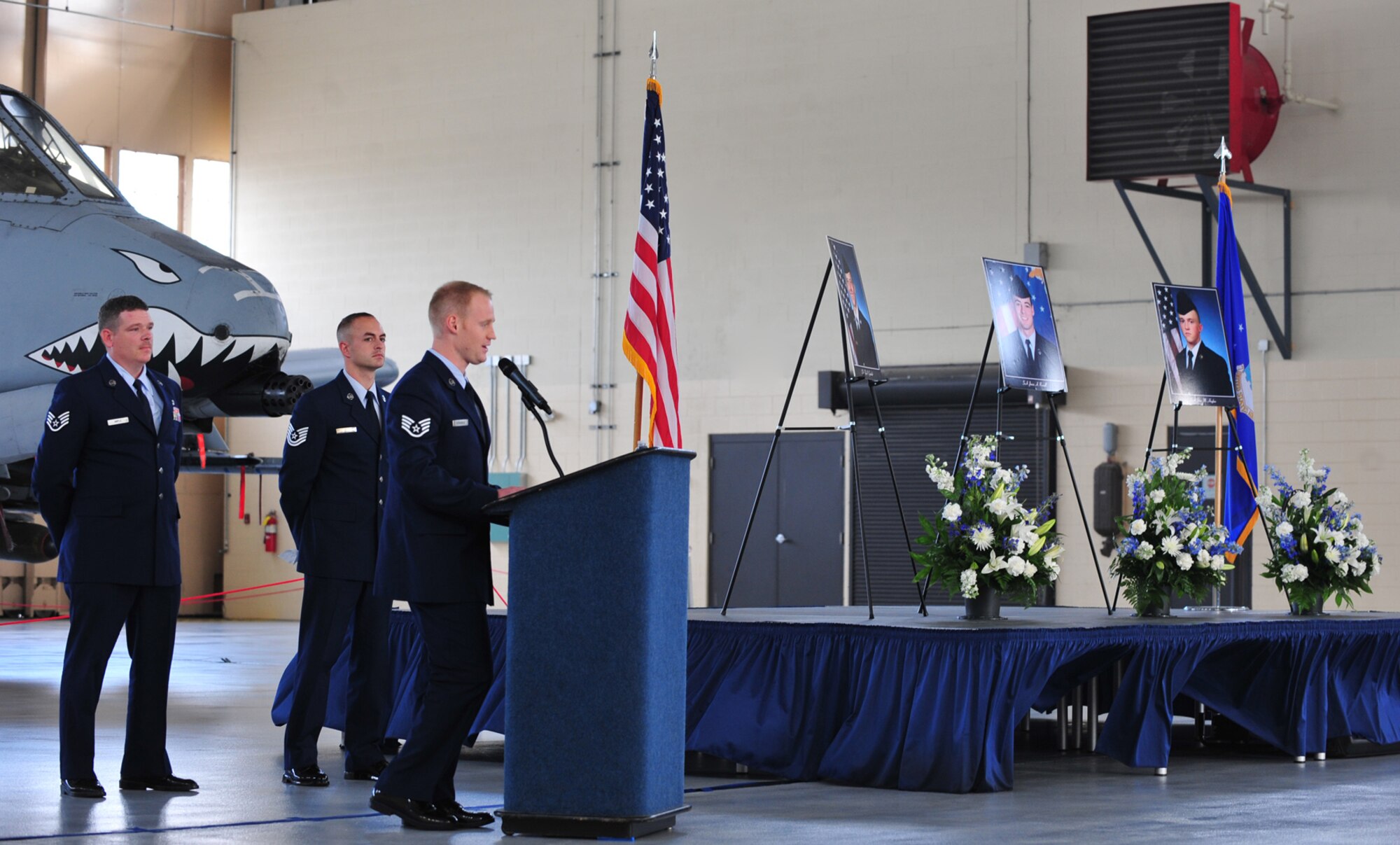 U.S. Air Force Staff Sgt.  Austin Strabala, forefront, Staff Sgt. Jason Maple, left, and Tech. Sgt. Dan Reed, 23rd Emergency Maintenance Squadron, share a few words about three Airmen who recently passed away during a memorial service at Moody Air Force Base, Ga., Nov. 22, 2011. The three Airmen were A-10C Thunderbolt II inspection section journeymen with the 23rd EMS. (U.S. Air Force photo by Staff Sgt. Stephanie Mancha/Released)
