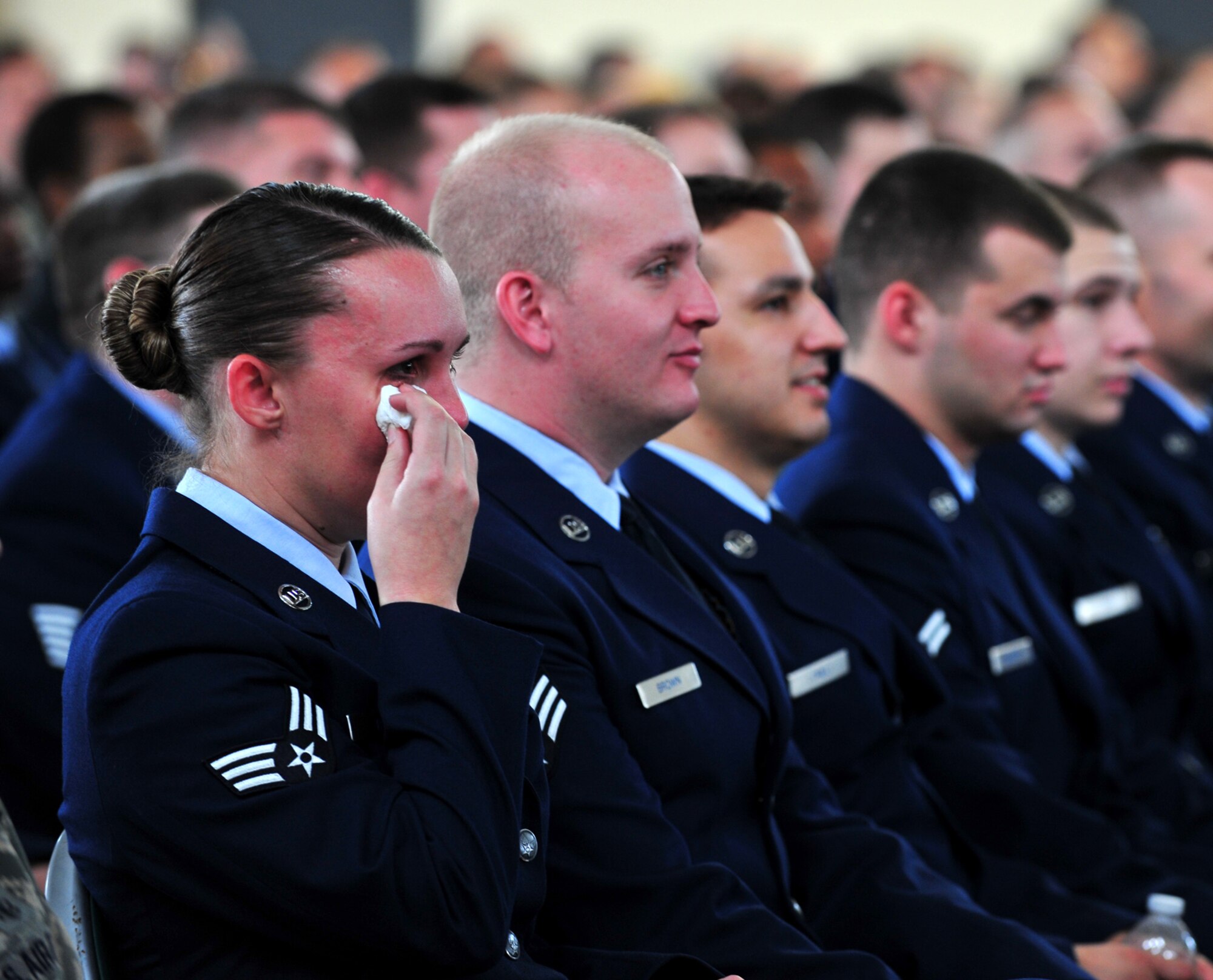 Members of Team Moody join together to mourn the loss of three Airmen who passed away after a single-vehicle automobile accident during a memorial service at Moody Air Force Base, Ga., Nov. 22, 2011. Many Airmen and civilians became emotional during a photo slideshow of the young Airmen that was played during the service. (U.S. Air Force photo by Staff Sgt. Stephanie Mancha/Released)
