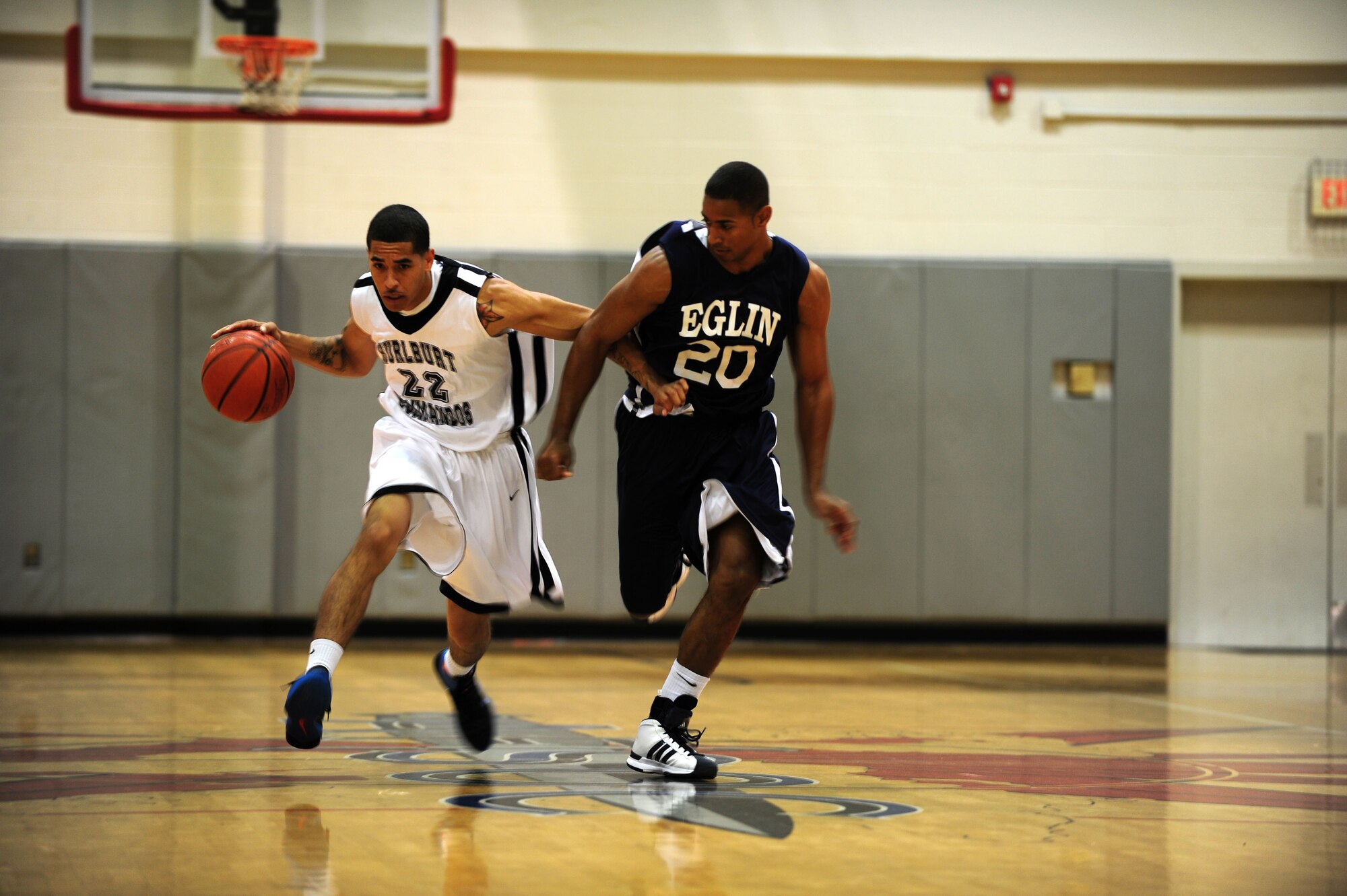 U.S. Air Force Robert Harp, shooting guard for the Hurlburt Field Commandos basketball team, dribbles against a player of the opposing team at the Aderholt Fitness Center on Hurlburt Field, Fla., Nov. 19, 2011.  The Commandos are part of the Southeastern Military Athletic Conference, consisting of six Air Force teams and one Navy team. (U.S. Air Force photo/Airman 1st Class Gustavo Castillo)(Released)