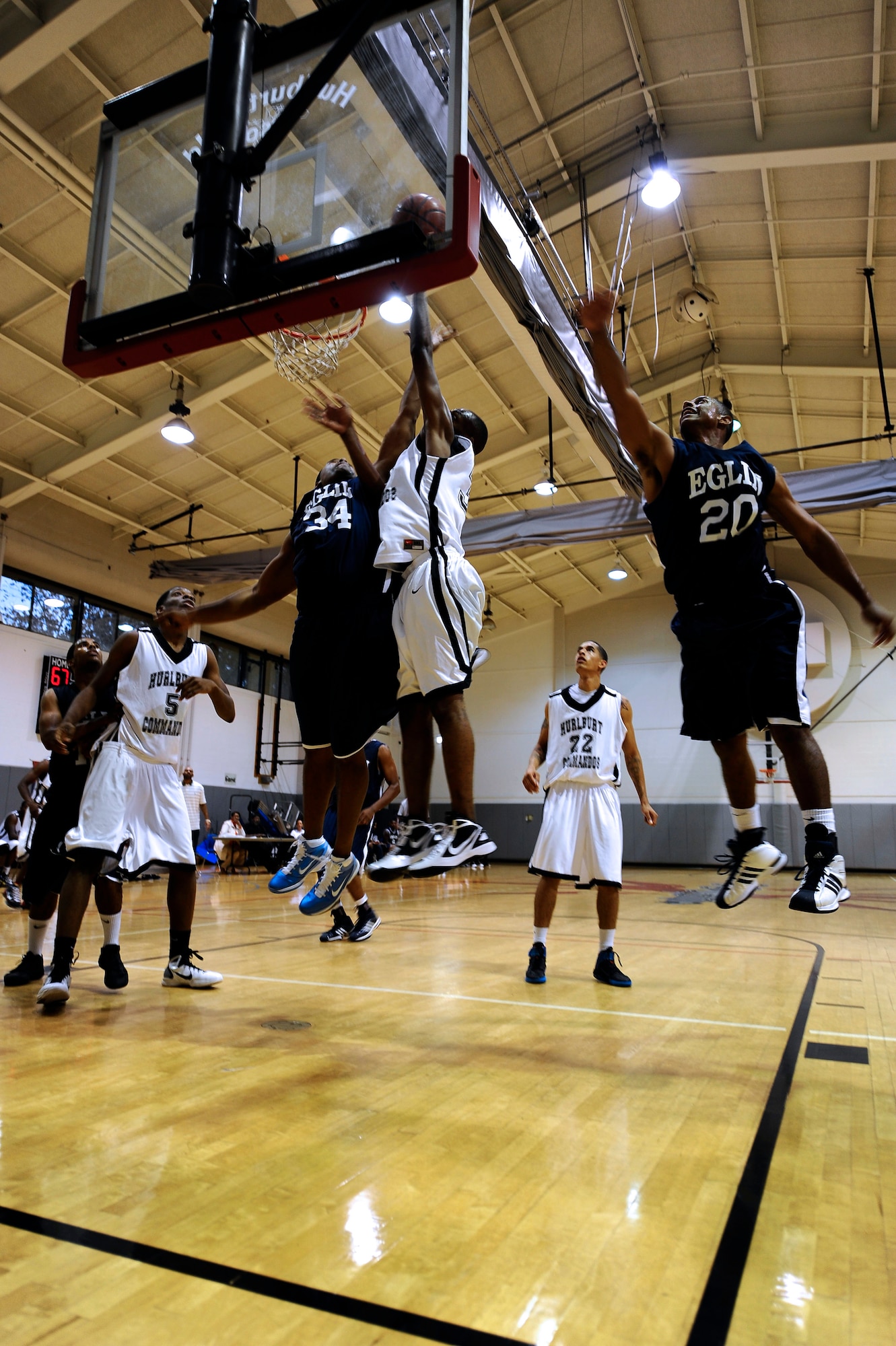 U.S. Air Force Tech. Sgt. Taveres Simpson, small forward for the Hurlburt Field Commandos basketball team, leaps into the air to score a point during a game at the Aderholt Fitness Center on Hurlburt Field Fla., Nov 19, 2011.  Simpson has been playing with the Hurlburt Field Commandos for three years. (U.S. Air Force photo/Airman 1st Class Gustavo Castillo)(Released)