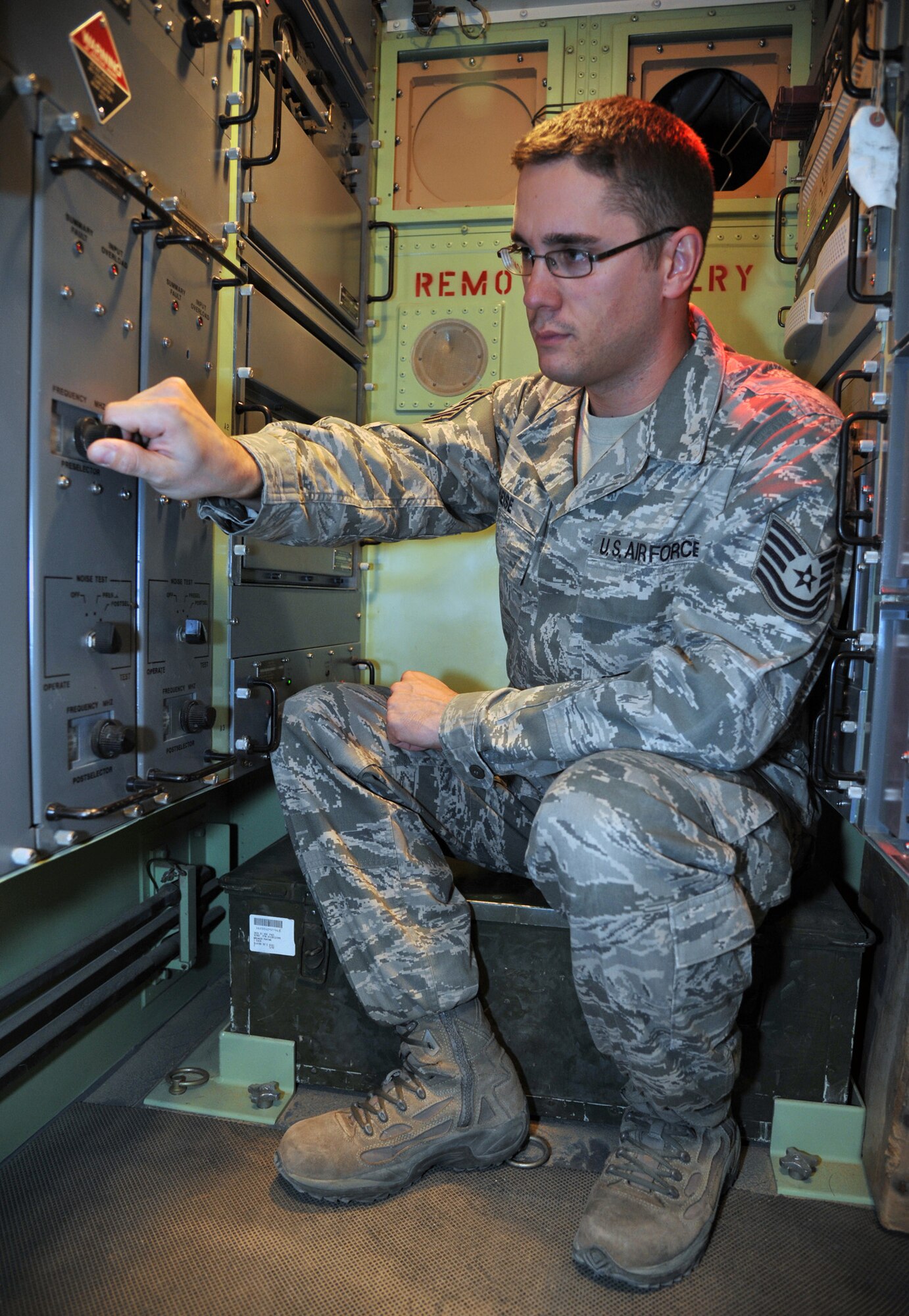 U.S. Air Force Tech Sgt. Daniel Heise performs receive signal level checks on the digital modem and adjusting the receiver frequency as part of his duties as the NCO-in-charge for the tropospheric scatter element for Alpha Battery, 1-44 Air Missile Defense Battalion at the 387th Air Expeditionary Group, Nov. 12, at an undisclosed location in Southwest Asia. The communications terminal allows the Patriot Missile Battery to receive and transmit radio and data traffic to the launch control battery at a different location. Heise is currently deployed from the 728th Air Control Squadron at Eglin Air Force Base, Fla. (U.S. Air Force photo/Master Sgt. Carlotta Holley)