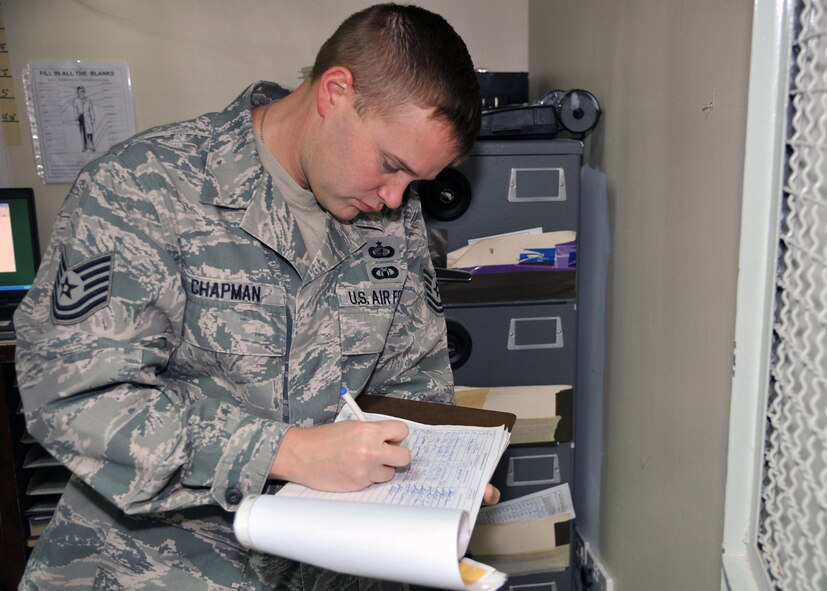 U.S. Air Force Tech Sgt. Philip M. Chapman signs a form stating that he  entered the cash cage at the beginning of the day as part of his duties as an paying agent at the 386th Air Expeditionary Wing, Nov. 2, 2011, at an undisclosed location in Southwest Asia. Chapman is currently deployed from the 96th Comptroller Squadron at Eglin Air Force Base, Fla.  (U.S. Air Force photo/Master Sgt. Carlotta Holley)