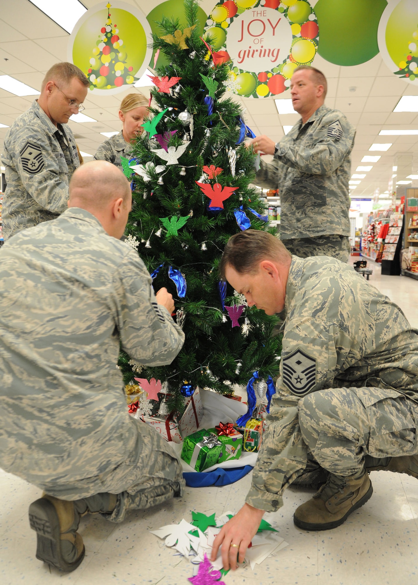 GOODFELLOW AFB, Texas – First Sergeants pitch in to decorate a tree with angels to kick off the Angel Tree Project at the Base Exchange Nov. 22. This is a program where people can pick an angel off the Christmas Tree, buy a gift card of any amount and give it to customer service to give to the First Sergeants Council. The cards are then distributed along with the food baskets the week prior to Christmas. (U.S. Air Force photo/ Staff Sgt. Tong Duong)