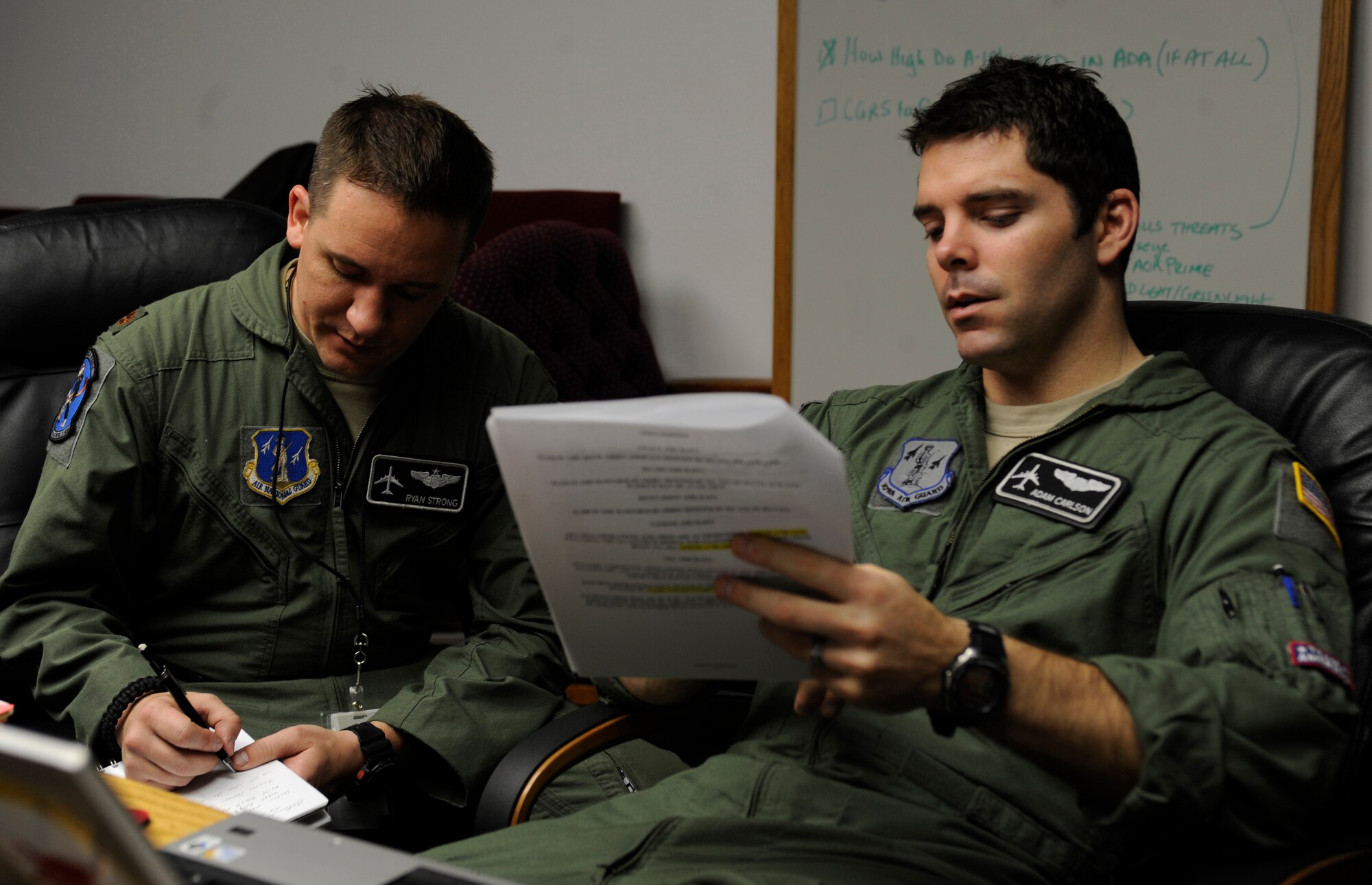 WHITEMAN AIR FORCE BASE, Mo. -- Maj. Ryan Strong and Capt. Adam Carlson, 509th Weapons Squadron, USAF Weapons School at Fairchild Air Force Base, Wa., review mission plans for their flight during the SMOKEX exercise over Kansas Nov. 16. SMOKEX is an exercise designed to enhance the proficiency of weapons school students in dynamic targeting operations. (U.S. Air Force photo/Staff Sgt. Alexandra M. Boutte) (RELEASED)