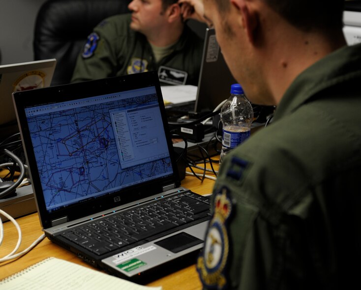WHITEMAN AIR FORCE BASE, Mo. -- Capt. Doug Murphy, 509th Weapons Squadron, U.S. Air Force Weapons School at Fairchild Air Force Base, Wash., reviews mission plans for their flight during the SMOKEX exercise over Kansas Nov. 16. SMOKEX is a large force exercise and runs the Smokey Hill Air National Guard unit near Salina, Kan. (U.S. Air Force photo by Staff Sgt. Alexandra M. Boutte)