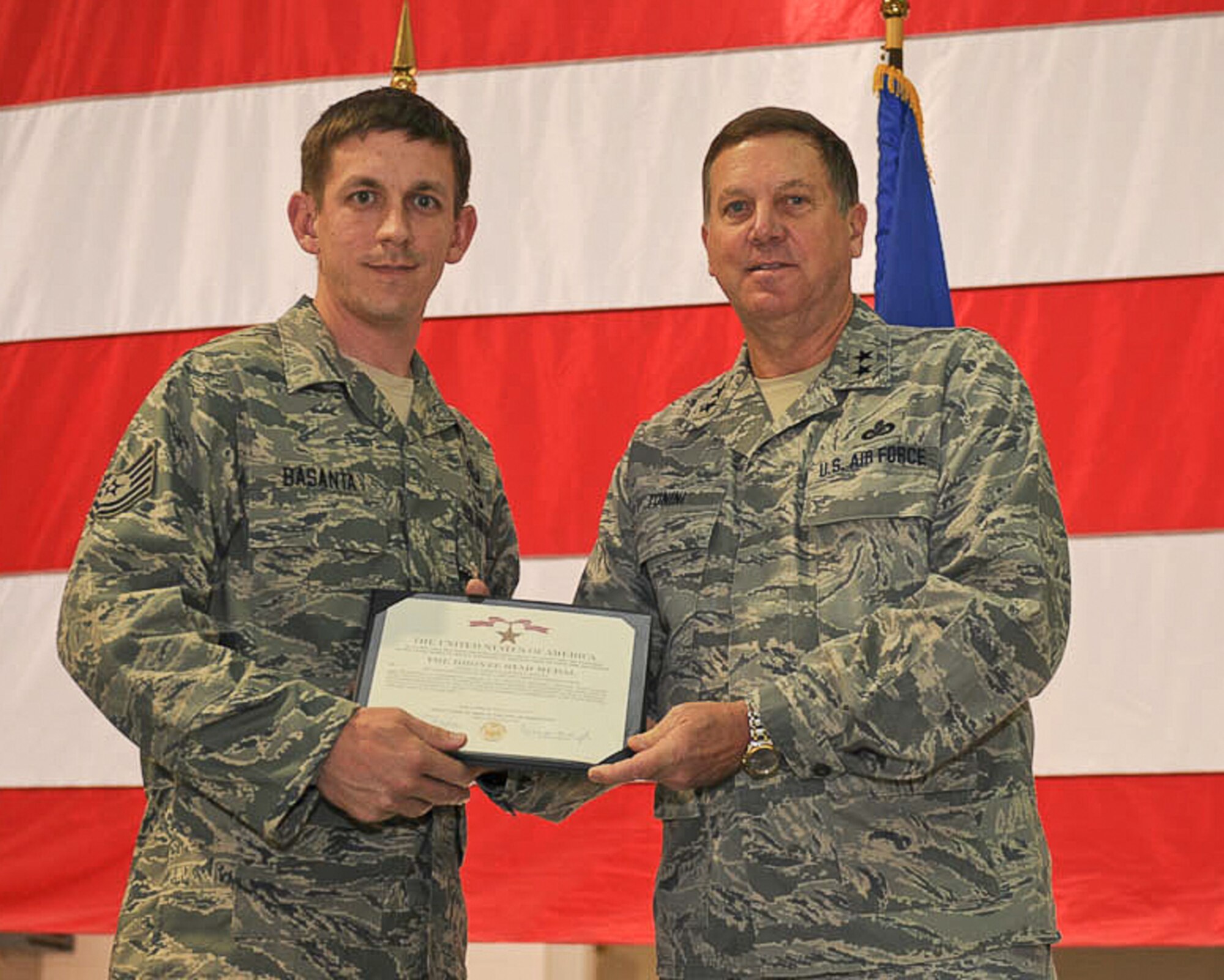 Kentucky???s adjutant general, Maj. Gen. Edward W. Tonini (right), presents Tech. Sgt. Matthew D. Basanta of the 123rd Civil Engineer Squadron with a Bronze Star Medal during a ceremony held Nov. 20, 2011, at the Kentucky Air National Guard Base in Louisville, Ky.  Meuser earned the combat decoration for his exceptionally meritorious service while deployed to Afghanistan as an explosive ordnance disposal team leader supporting Operation Enduring Freedom. (U.S. Air Force photo by Tech. Sgt. Dennis Flora)