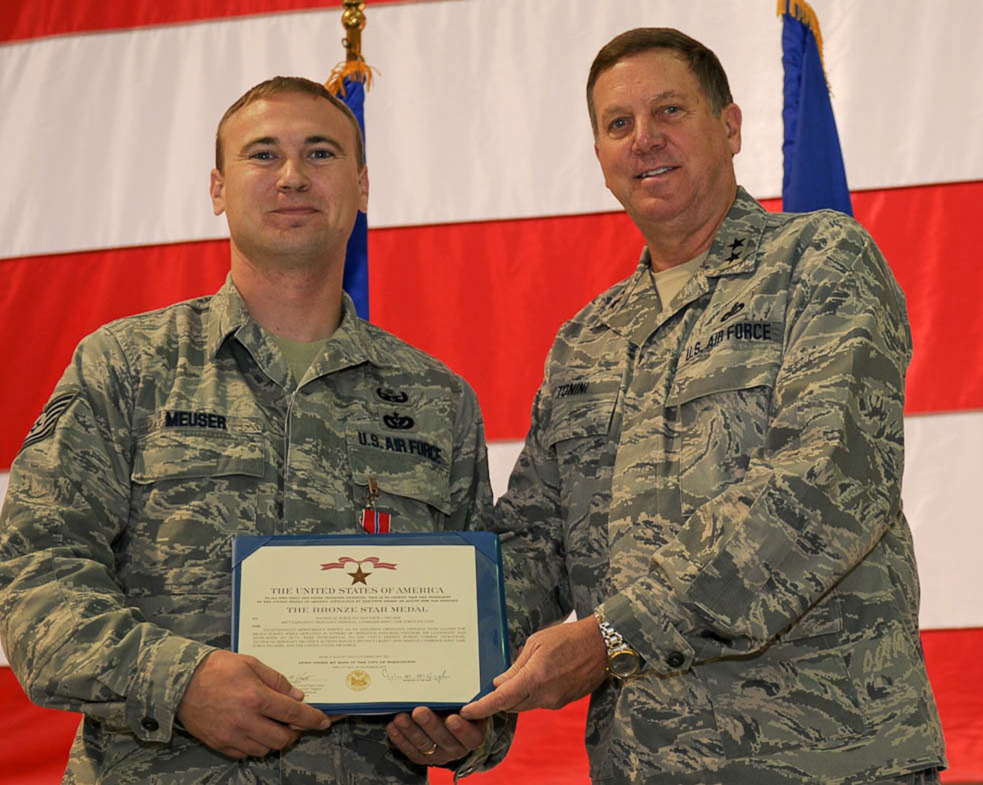 Kentucky???s adjutant general, Maj. Gen. Edward W. Tonini (right), presents Tech. Sgt. Matthew J. Meuser of the 123rd Civil Engineer Squadron with a Bronze Star Medal during a ceremony held Nov. 20, 2011, at the Kentucky Air National Guard Base in Louisville, Ky.  Meuser earned the combat decoration for his exceptionally meritorious service while deployed to Afghanistan as an explosive ordnance disposal team leader supporting Operation Enduring Freedom. (U.S. Air Force photo by Tech. Sgt. Dennis Flora)