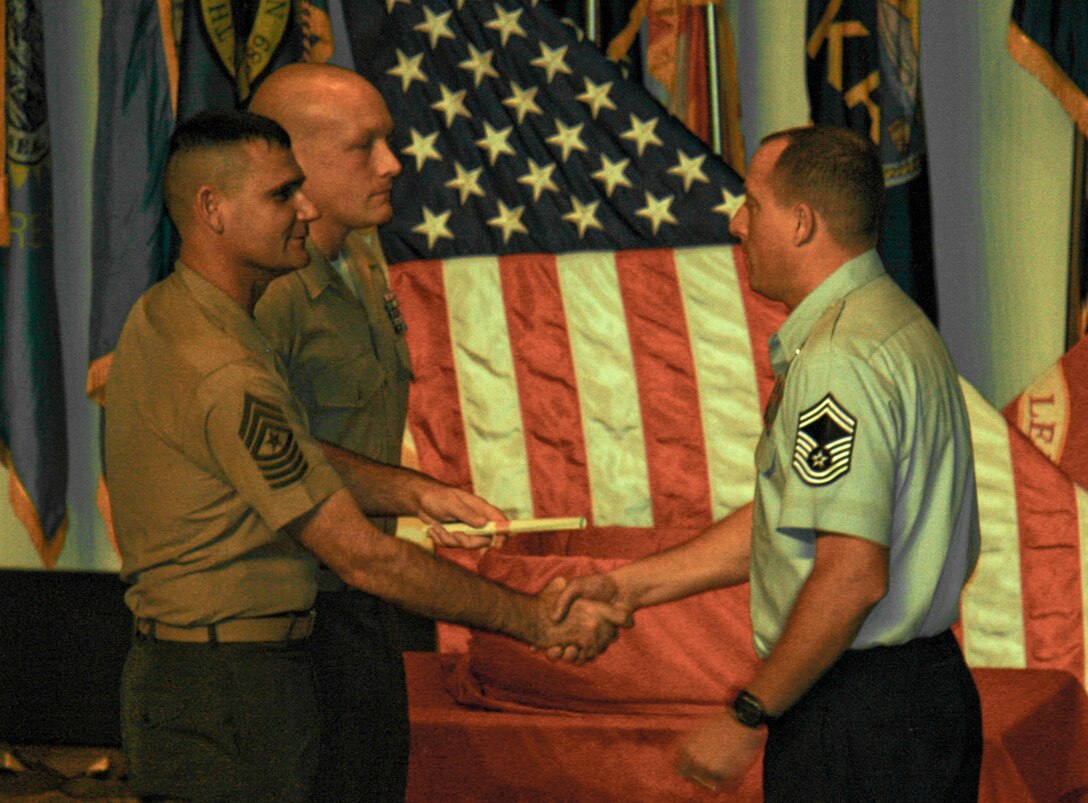 Senior Master Sgt. Bruce Tims, of the 919th Operations Support Squadron, accepts his certificate of training at his graduation from the Marine Corps Staff NCO Academy, Advanced Course at Camp Lejeune, N.C. Oct. 14.  Tims was the first Air Force reservist to graduate the Marine leadership course. (Courtesy photo)