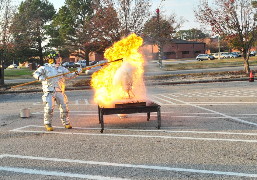 Airman 1st Class Daniel Morgan quickly backs away from a grease fire during the Turkey Fryer Fire demonstration at Seymour Johnson Air Force Base, N.C., Nov. 22, 2011. In less than five seconds, flames completely engulfed the pot and the supporting structure, representing the severity of what can happen when someone attempts to fry a turkey that has not been properly unthawed. Morgan, a driver operator with the 4th Civil Engineer Squadron fire services flight, hails from Idahla Falls, Idaho. (U.S. Air Force photo by Senior Airman Marissa Tucker)