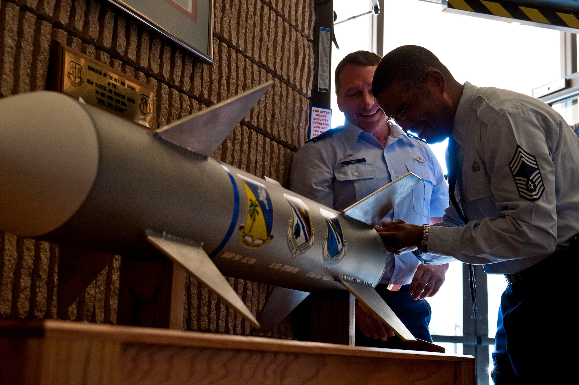 Col. David Hicks, the 53rd Wing commander and Chief Master Sgt. Philip Robinson, 53rd WG’s acting command chief, close up a time capsule at Eglin Air Force Base, Fla., Nov. 21.  The time capsule, built exclusively by 53rd Wing units, was filled with wing coins, hats and other 2011 artifacts on the 70th anniversary of the wing.  The capsule will sit in the lobby of the headquarters building until its reopened in 2041, the wing’s 100th anniversary.  (U.S. Air Force photo/Samuel King Jr.)  