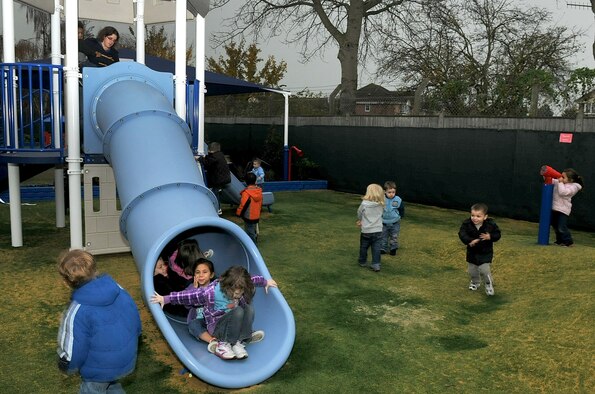 RAF MILDENHALL, England – Children break in the new playground equipment following an opening ceremony at the RAF Mildenhall Child Development Center Nov. 22, 2011. The playground planning stages took three years to complete and construction officially began in October 2011. (U.S. Air Force photo/Senior Airman Jerilyn Quintanilla)