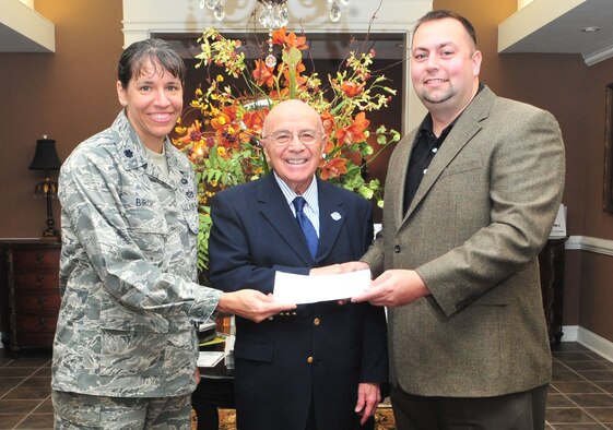 Lt. Col. Amanda Birch (left), George Silver (middle) and Chris White pose for a photo after White donates a check to the Air Force Association (AFA) scholarship fund, Nov. 18, 2011. White, a representative from the Fastenal Company, donated the funds to the AFA to give back to the Air Force community. The AFA lobbies for Airmen and retiree benefits and gives more than six scholarships each year to Airmen and dependents. Birch is the 4th Civil Engineer Squadron individual mobilization augmentee commander and George Silver is the AFA president.  (U.S. Air Force photo by Senior Airman Marissa Tucker)