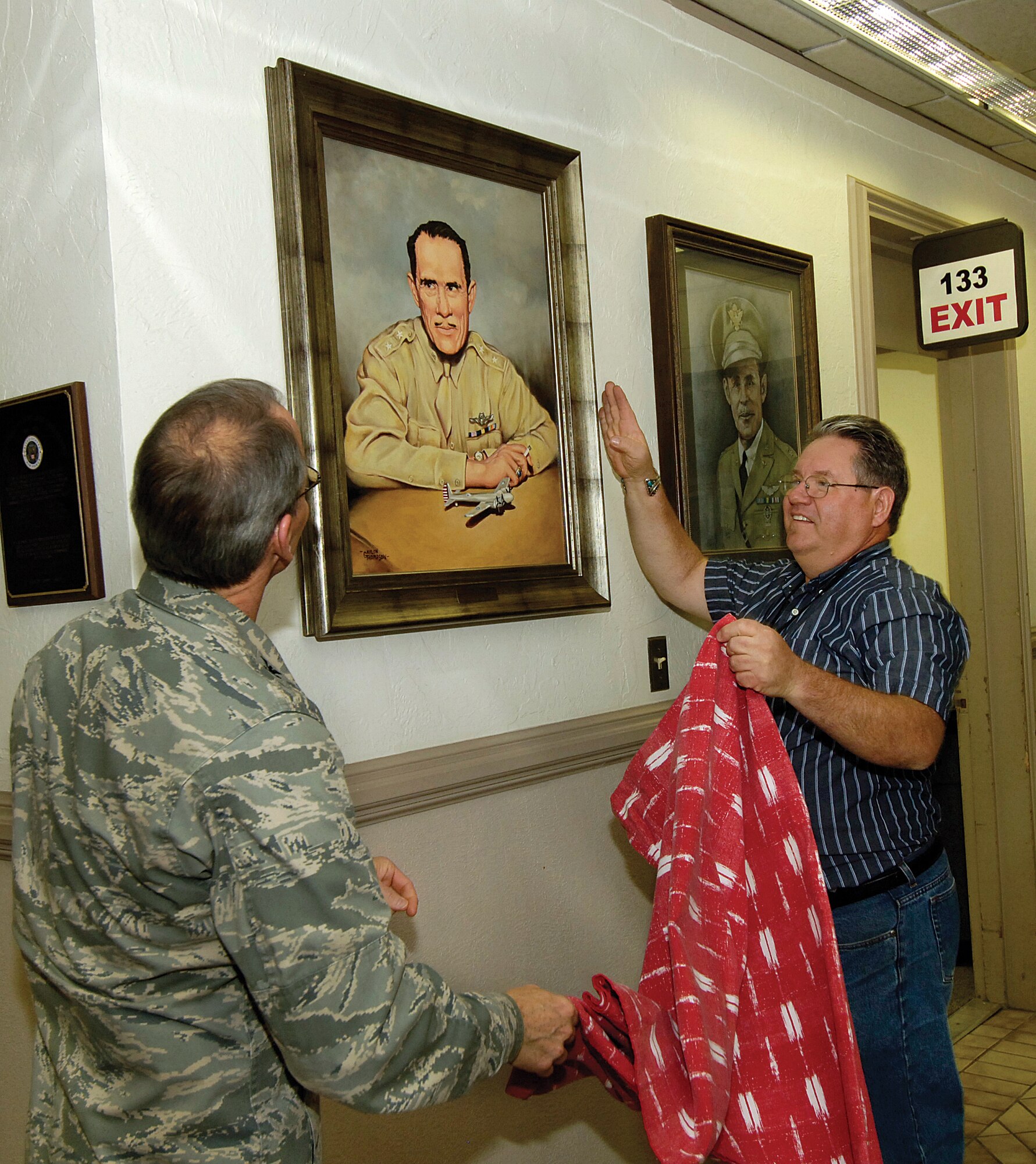Col. Bob LaBrutta, 72nd Air Base Wing and Tinker Installation commander and artist Gaylon Thompson unveil Mr. Thompson’s portrait of Maj. Gen. Clarence Tinker Nov. 17 now hanging in the lobby of the 72nd ABW headquarters, Bldg. 460. Mr. Thompson donated the oil on linen portrait he did from an historical photo of the Tinker Air Force Base namesake, originally painted several years ago for the Oklahoma Centennial celebration. Besides painting and teaching painting, Mr. Thompson is a Tinker welder, working in the 550th Commodities Maintenance Squadron. (Air Force photo by Margo Wright)
