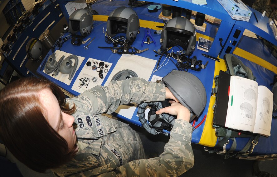 Senior Airman Emily Bertini, 333rd Fighter Squadron aircrew flight equipment journeyman, replaces the combat edge bladder on a aircrew helmet at Seymour Johnson Air Force Base, N.C., Nov. 22, 2011. The bladder is designed to inflate while aircrew are pulling G?s to keep their mask in position. Bertinit hails from Springtown, Texas. (U.S. Air Force photo by Senior Airman Gino Reyes)