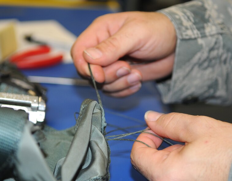 Tech. Sgt. Steven Beaudrot, 333rd Fighter Squadron aircrew flight equipment technician, replaces the tacking on a personal lowering device (PLD) at Seymour Johnson Air Force Base, N.C., Nov. 22, 2011. The PLD is used by aircrew after egressing in order to to lower themselves from trees or other objects high off the ground. Beaudrot hails from Charleston S.C. (U.S. Air Force photo by Senior Airman Gino Reyes)