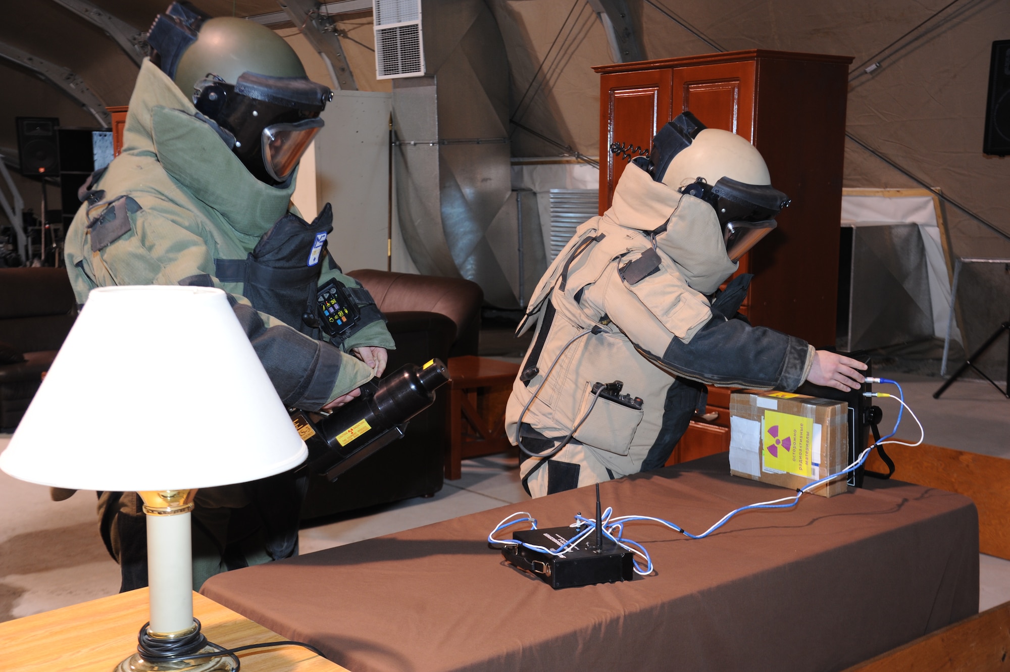 Staff Sgt. Matt Leatherman (tan suit) helps a Kyrgyz Republic soldier and fellow explosive ordnance disposal technician place an x-ray machine by a potential bomb during an information exchange exercise at the Transit Center at Manas, Kyrgyzstan, Nov. 22. Leatherman is deployed to the 376th Expeditionary Civil Engineer Squadron from Mountain Home Air Force Base, Idaho. (U.S. Air Force photo/Tech. Sgt. Hank Hoegen)
