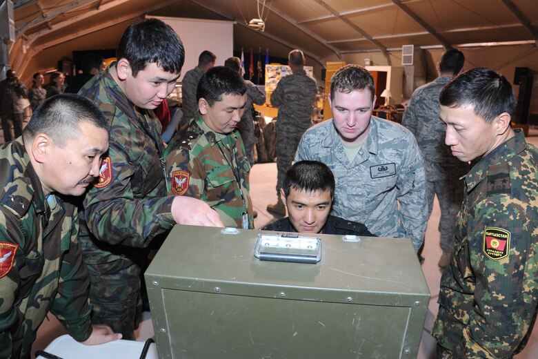 Staff Sgt. Paul Pest watches as a Kyrgyz Ministry of Interior explosive ordnance disposal technician maneuvers an F6A robot through a staged apartment during an information exchange at the Transit Center at Manas, Kyrgyzstan, Nov. 22. Pest is a 376th Expeditionary Civil Engineer Squadron EOD technician deployed here from Seymour Johnson Air Force Base, N.C. (U.S. Air Force photo/Tech. Sgt. Hank Hoegen)