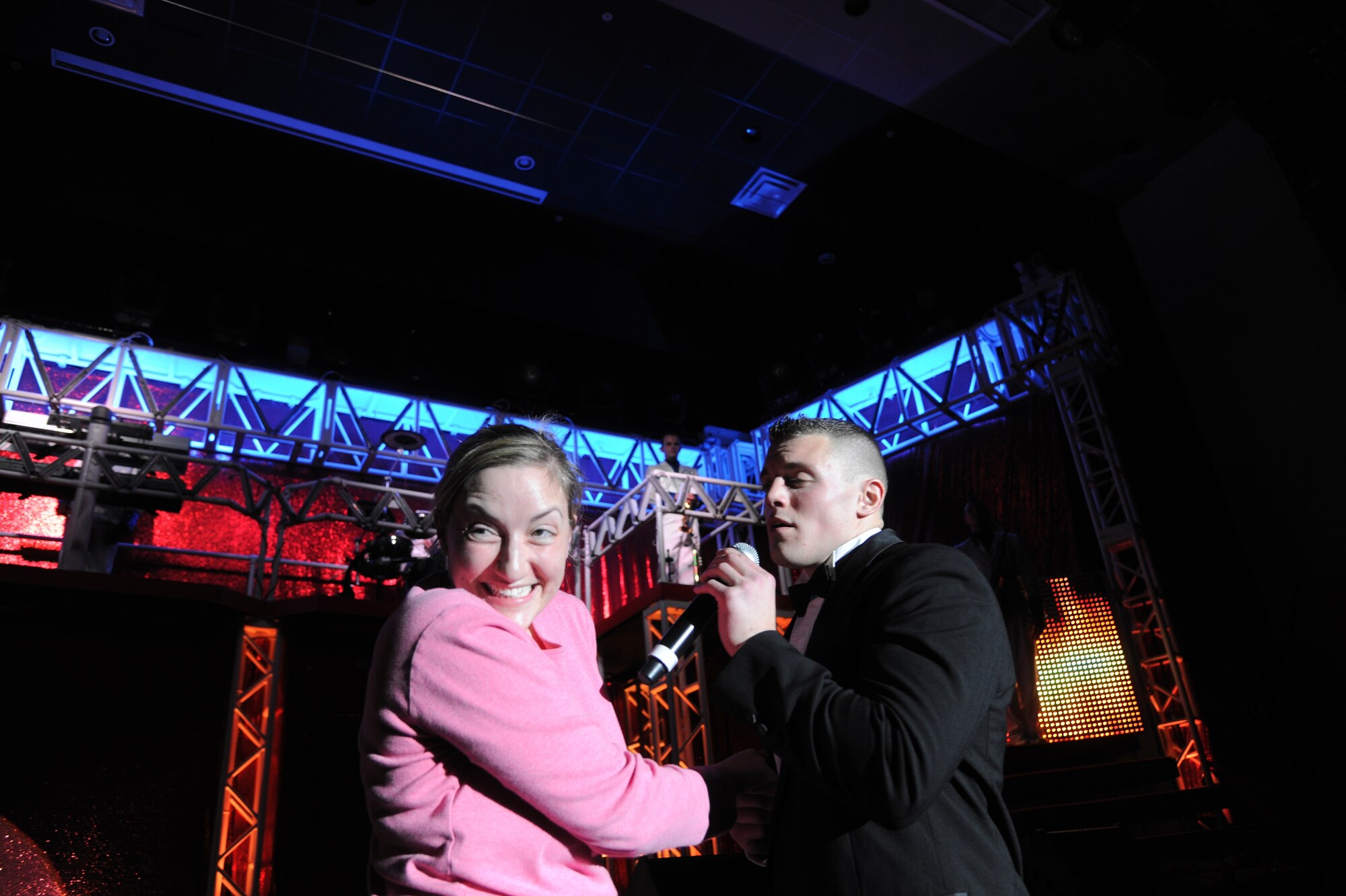 1st Lt. Robert Doyle serenades Staff Sgt. Mae O’Brien, 8th Medical Support Squadron on stage during a Tops In Blue concert at Kunsan Air Base, Republic of Korea, Nov. 22, 2011. This year’s tour, entitled Rhythm Nation, brings to life the music of America, from the early 1900s through today. (U.S. Air Force photo by Master Sgt. Sonny Cohrs/Released) 