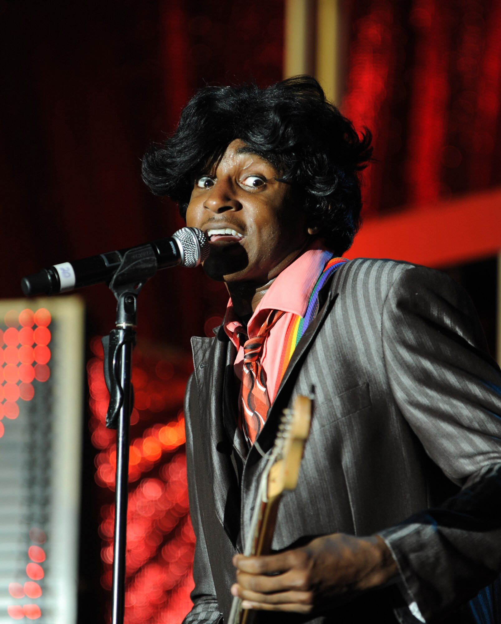 Airman 1st Class Steve Pearson sings in character during a Tops In Blue concert at Kunsan Air Base, Republic of Korea, Nov. 22, 2011. Tops In Blue, is an all-active duty US Air Force special unit made up of talented amateur performers selected for their entertainment abilities. (U.S. Air Force photo by Master Sgt. Sonny Cohrs/Released)