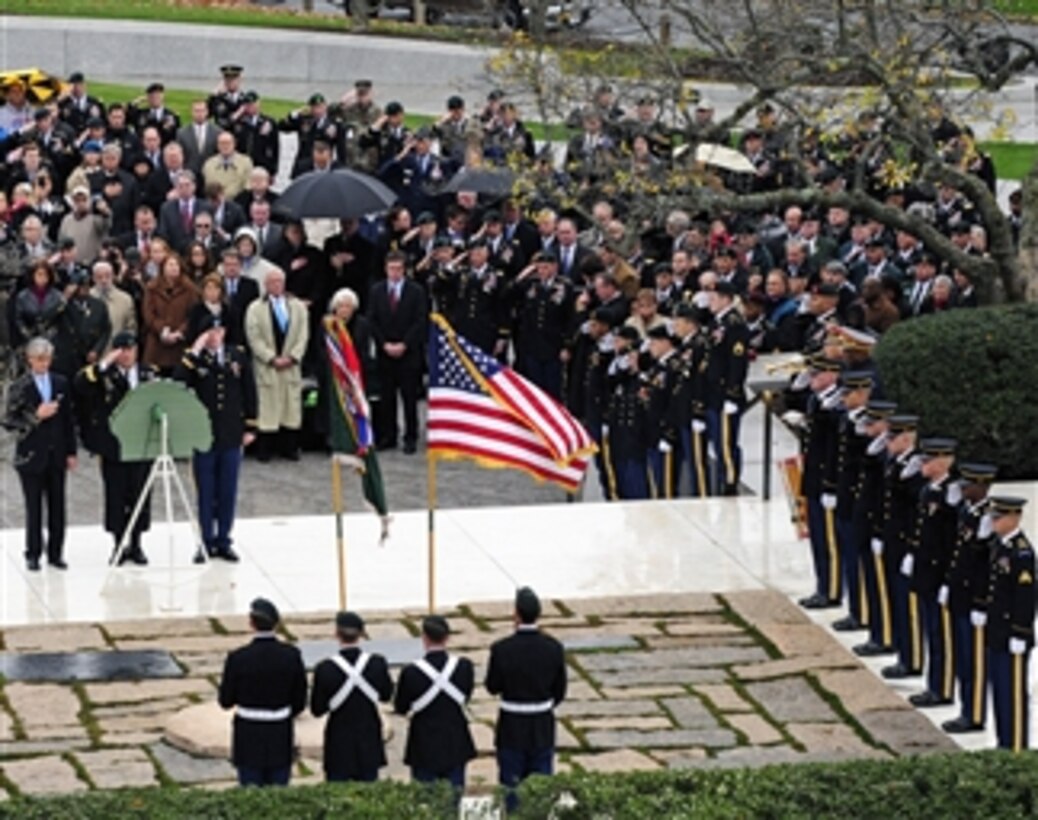 U.S. Army soldiers (right) of the 3rd U.S. Infantry Regiment (The Old Guard) render honors during the playing of Taps at a wreath laying ceremony at the grave site of President John F. Kennedy in Arlington National Cemetery, Va., on Nov. 17, 2011.  The ceremony, hosted by the U.S. Army Special Forces Command (Airborne) and supported by The Old Guard, commemorated the 50th anniversary of the wearing of the Green Beret, authorized by Kennedy in 1961.  This important vision and the subsequent lasting partnership between Kennedy and the Special Forces ensure that these men will forever wear the Green Beret.  