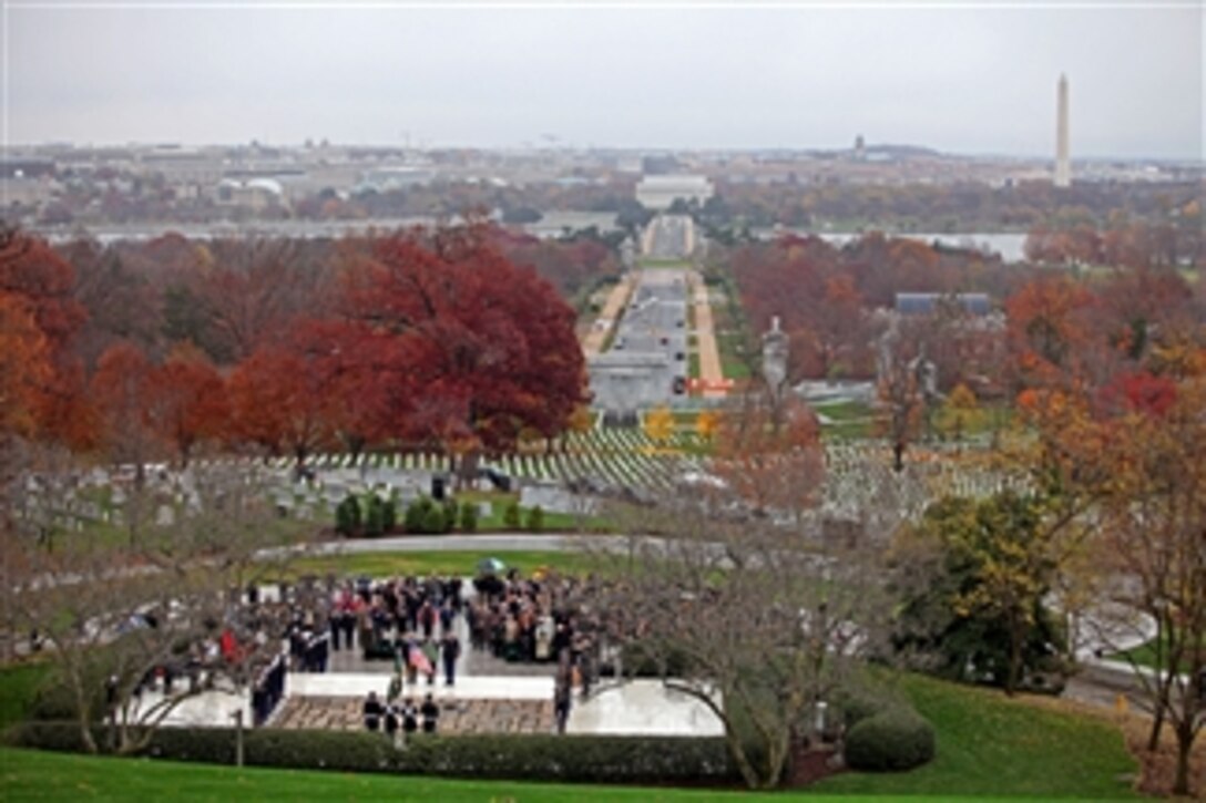 Soldiers of the 3rd U.S. Infantry Regiment (The Old Guard) render honors during the playing of Taps at a wreath laying ceremony at the grave site of President John F. Kennedy in Arlington National Cemetery, Va., on Nov. 17, 2011.  The ceremony, hosted by the U.S. Army Special Forces Command (Airborne) and supported by The Old Guard, commemorated the 50th anniversary of the wearing of the Green Beret, authorized by Kennedy in 1961.  This important vision and the subsequent lasting partnership between Kennedy and the Special Forces ensure that these men will forever wear the Green Beret.  