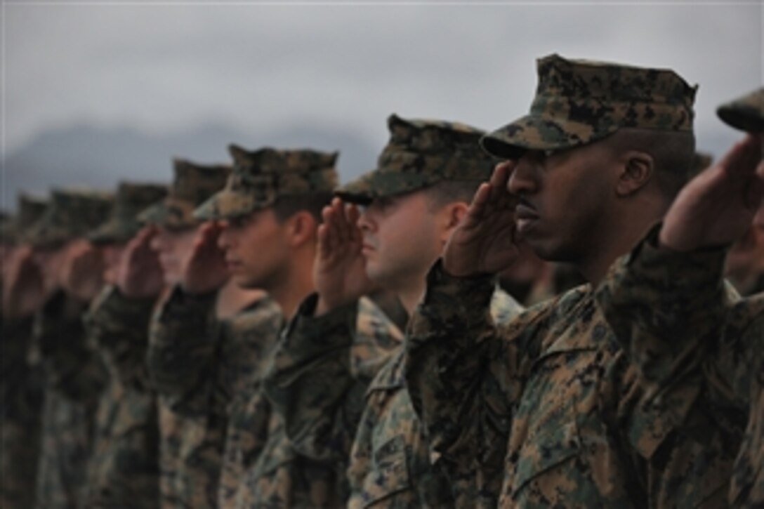 U.S. Marine Corps Staff Sgt. Brandon S. Foote (right) and others salute the USS Arizona memorial from the amphibious assault ship USS Makin Island (LHD 8) in Pearl Harbor, Hawaii, on Nov. 21, 2011.  The unit embarked aboard the USS Makin Island, the USS New Orleans and the USS Pearl Harbor in San Diego on Nov. 14 to begin a seven-month deployment through the western Pacific and Middle East regions.  