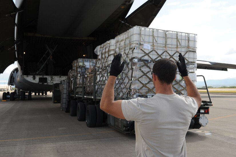 SOTO CANO AIR BASE, Honduras - An Airman from the 612th Air Base Squadron helps unload  cargo off a C-5 Galaxy here Nov. 17, 2011. Air Force Reservists from the 439th Airlift Wing, Westover Air Reserve Base, Mass., delivered 45,000 pounds of humanitarian aid through the Denton Program.  Joint Task Force-Bravo supports humanitarian and civic assistance missions throughout Central America to enhance theater-wide security, stability and prosperity and reinforce cooperation. (U.S. Air Force photo/Tech. Sgt. Matthew McGovern) 