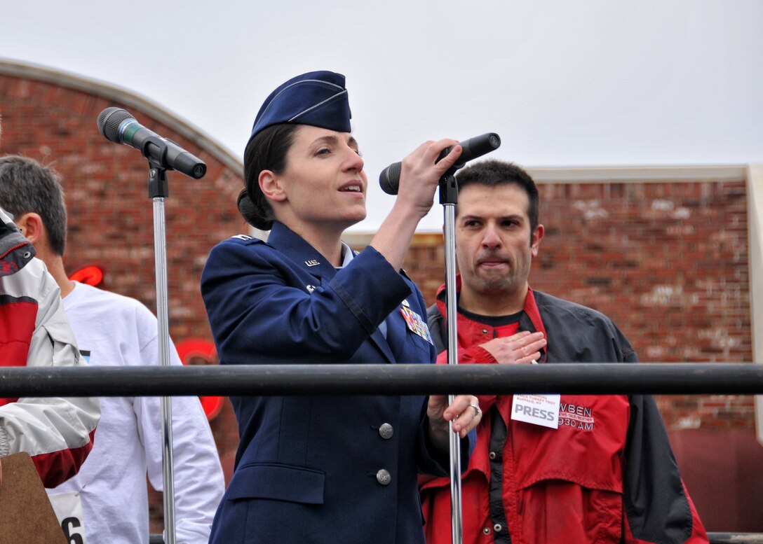 Capt. Gina Pizziconi-Cupples, 914th Logistics Readiness Squadron commander sings the National Anthem during the opening of the 116th annual YMCA Turkey Trot held Thanksgiving morning November 24, 2011 Buffalo NY. Established in 1896, this 8K race marked its 116th start on Thanksgiving morning, making it the oldest continually running footrace in North America. . (U.S. Air Force photo by Staff Sgt. Joseph McKee)