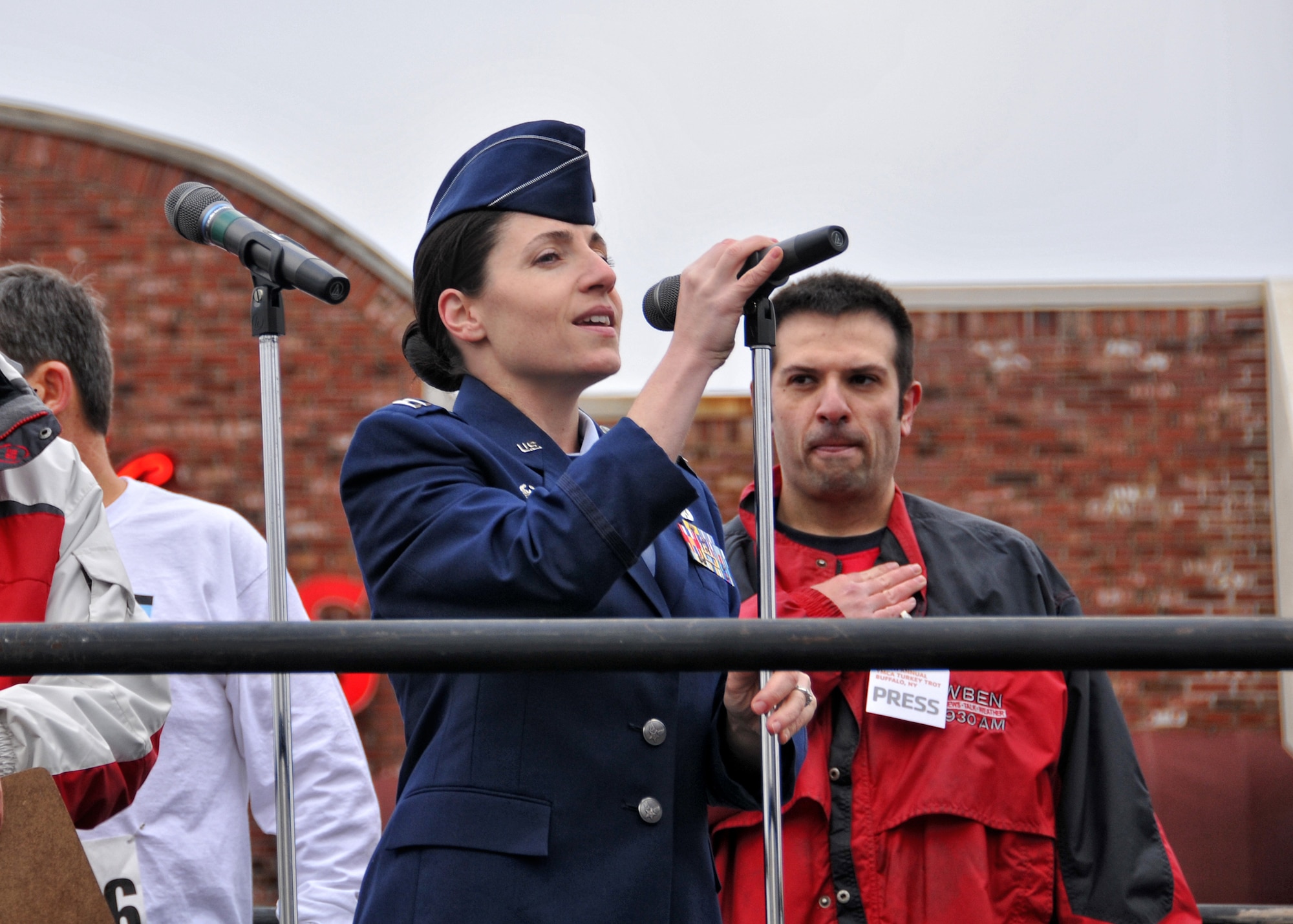 Capt. Gina Pizziconi-Cupples, 914th Logistics Readiness Squadron commander sings the National Anthem during the opening of the 116th annual YMCA Turkey Trot held Thanksgiving morning November 24, 2011 Buffalo NY. Established in 1896, this 8K race marked its 116th start on Thanksgiving morning, making it the oldest continually running footrace in North America. . (U.S. Air Force photo by Staff Sgt. Joseph McKee)
