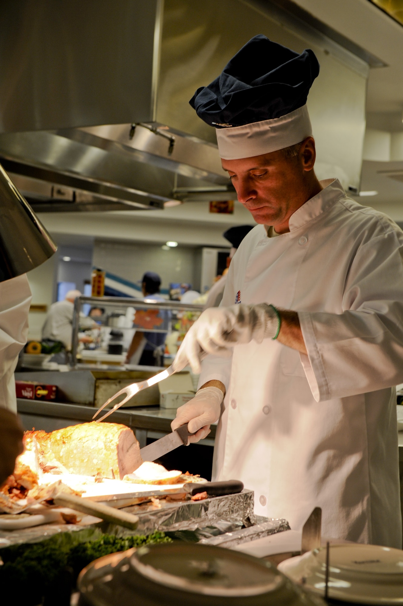 VANDENBERG AIR FORCE BASE, Calif. – Col. Richard Boltz, 30th Space Wing commander, carves a turkey roast for a Thanksgiving Day dinner at Breakers Dining Facility here Thursday, Nov. 24, 2011. Breakers was open to all military members and idenfication card holders for a Thanksgiving Day celebration. (U.S. Air Force photo/Staff Sgt. Levi Riendeau)
