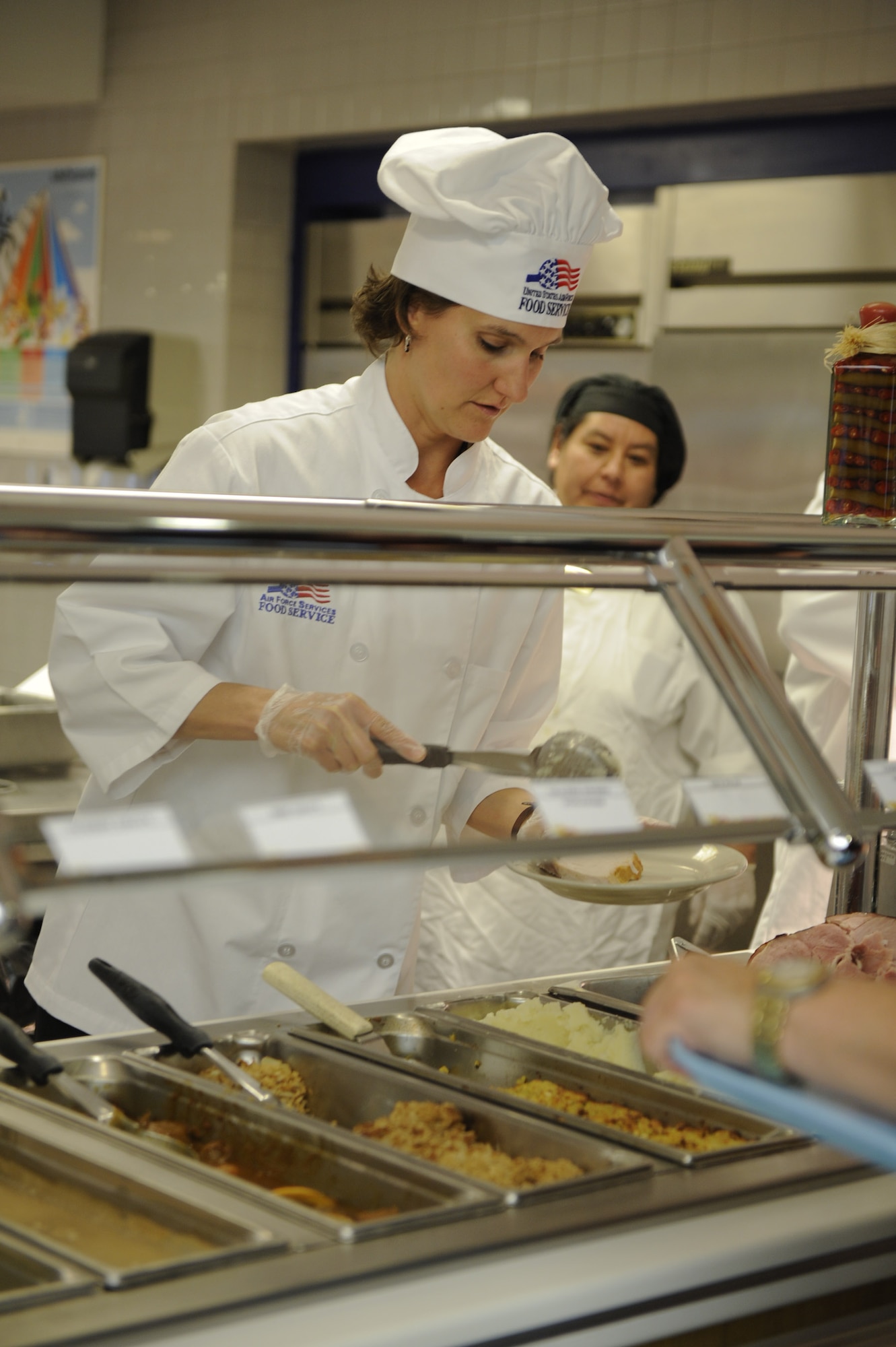 VANDENBERG AIR FORCE BASE, Calif. -- Mrs. Cindy Boltz, the 30th Space Wing commander's wife, serves Thanksgiving dinner at Breakers Dining Facility here Thursday, Nov. 24, 2011. Breakers was open to all military members and idenfication card holders for a Thanksgiving Day celebration. (U.S. Air Force photo/Staff Sgt. Levi Riendeau)