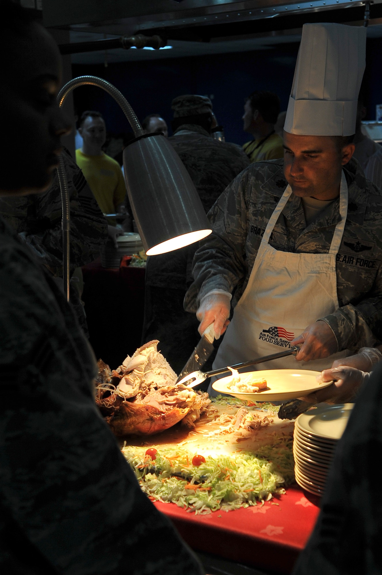 Maj. Michael Brazda, 379th Air Expeditionary Wing executive officer, carves a turkey to be served to Airmen and coalition partners during a Thanksgiving Day meal Nov. 24, 2011, at an undisclosed location in Southwest Asia. (U.S. Air Force photo/Senior Airman Paul Labbe)
