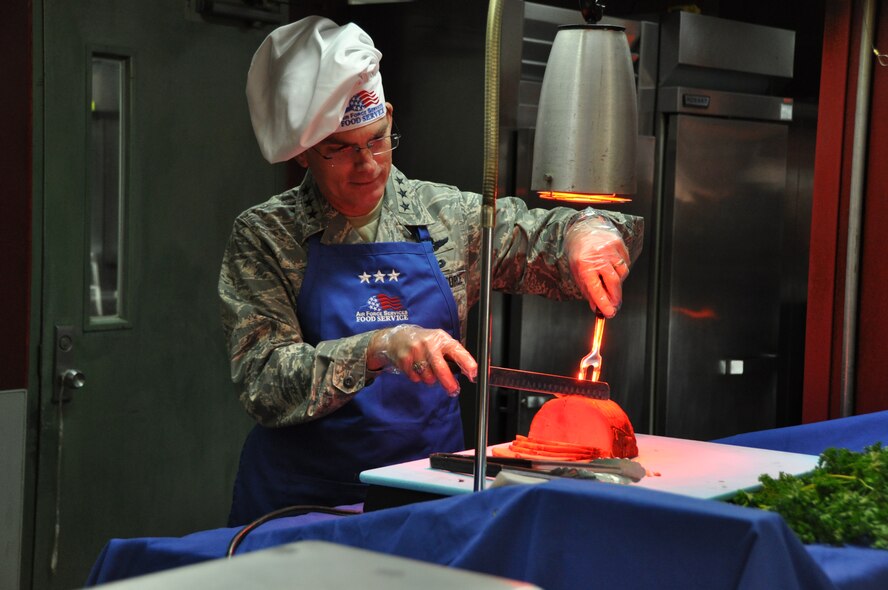 Lt. Gen. Paul Selva, Pacific Air Force vice commander, serves holiday ham during Thanksgiving dinner to Airman and Soldiers assigned to Osan Air Base, Republic of Korea, Nov. 24. The Ginko Tree dining facility prepared 630 pounds of turkey, 150 pounds of ham, 210 pounds of roast beef and served nearly 2,000 service member. (U.S. Air Force photo/Airman 1st Class Michael Battles) 
 

