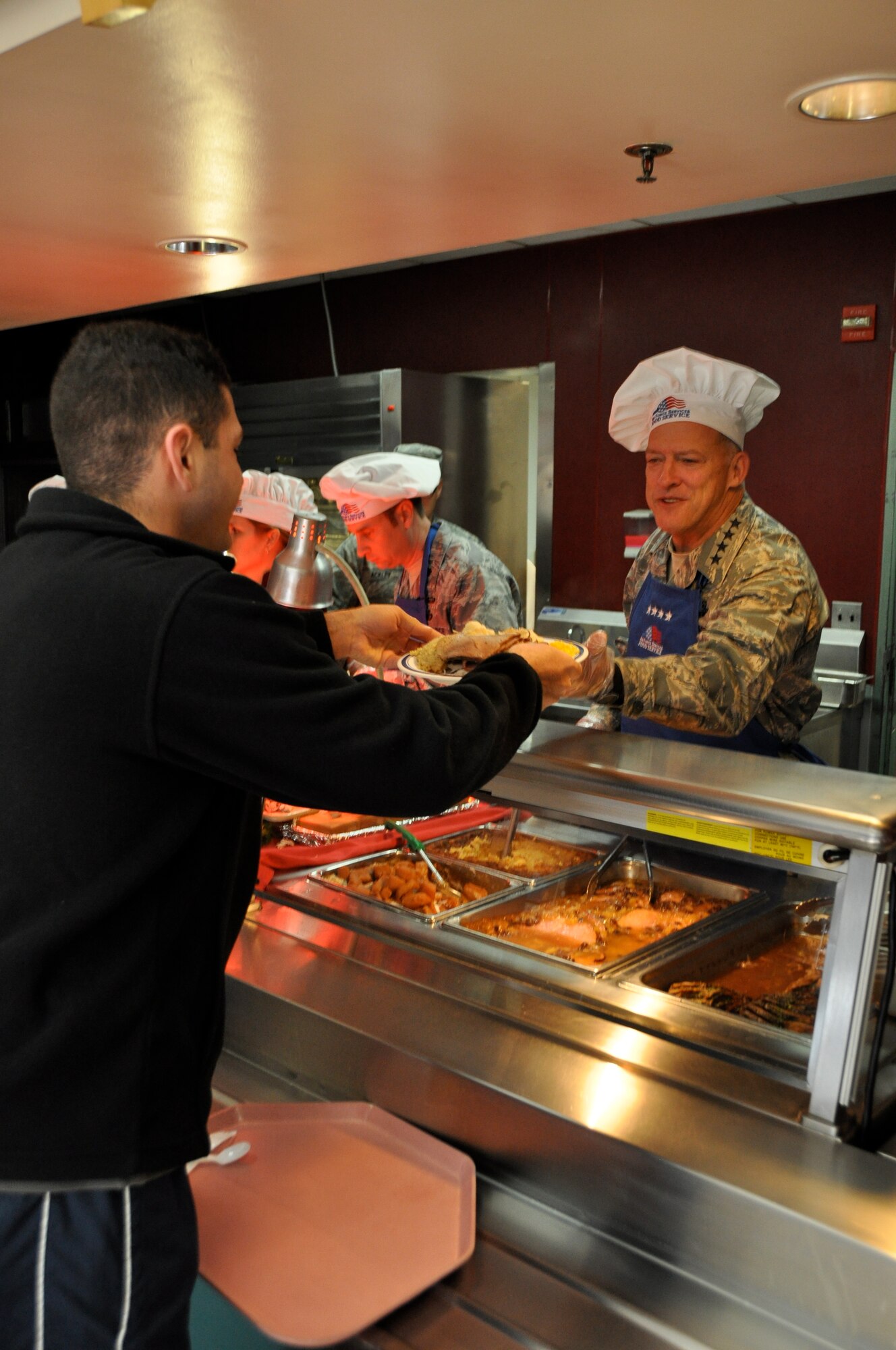 Gen. Gary North, Pacific Air Force commander, serves Thanksgiving dinner to Airman and Soldiers assigned to Osan Air Base Nov. 24, 2011.  The Ginko Tree dining facility prepared 630 lbs of turkey, 150 lbs of Ham, 210 lbs of roast beef and served nearly 2,000 service member. 
