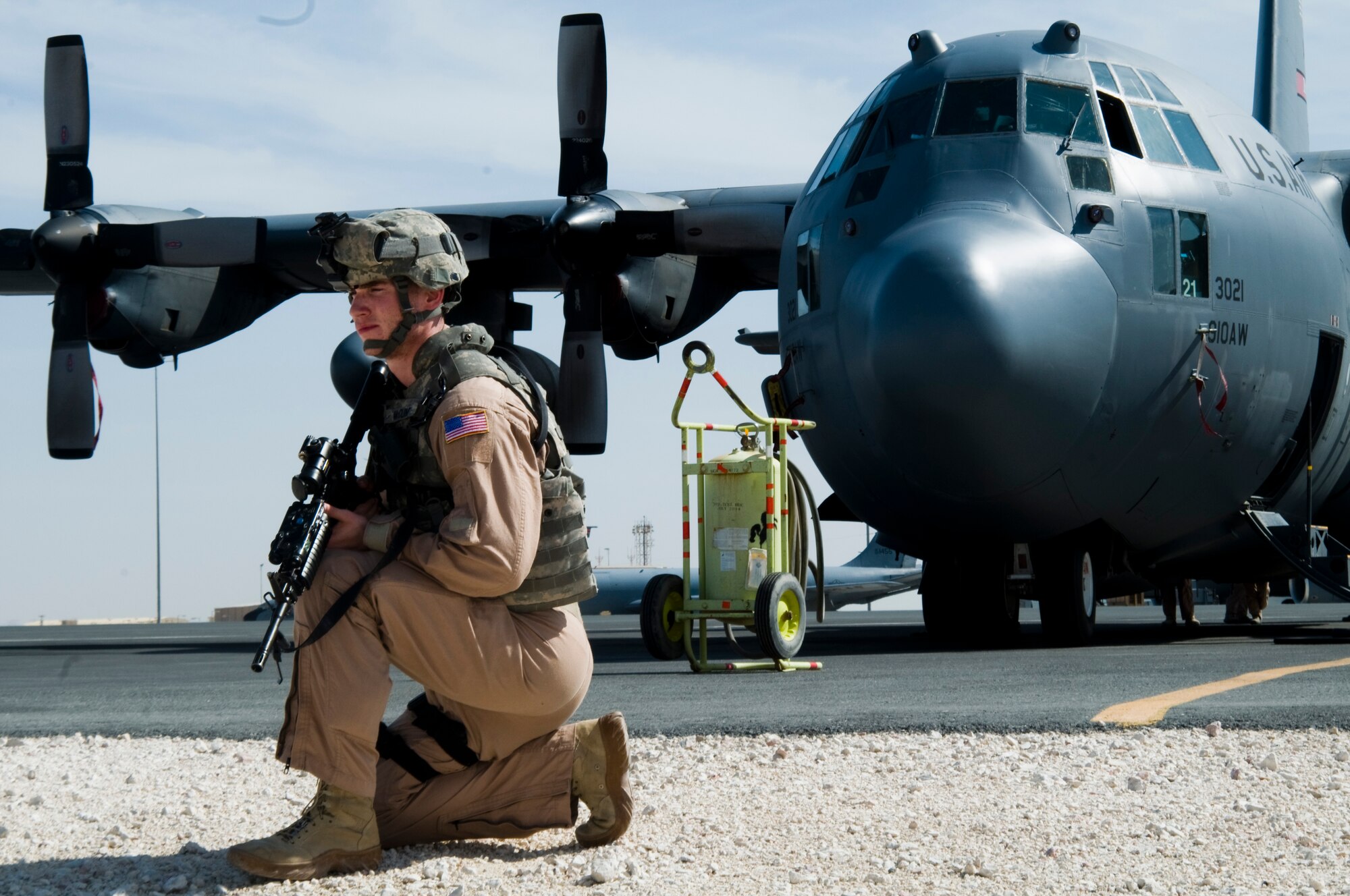 Airman 1st Class David McCune, 379th Expeditionary Security Forces Squadron Fly Away Security Team member, assumes a defensive posture while training to provide security for a C-130 Hercules Nov. 17, 2011, at an undisclosed location in Southwest Asia. The FAST mission is to travel with aircraft and provide security at locations around the area of responsibility that the Department of Defense has deemed to be unsecure. McCune, a native of Anchorage, Alaska, is deployed from Hill Air Force Base, Utah. (U.S. Air Force photo/Senior Airman Eric Summers Jr.)