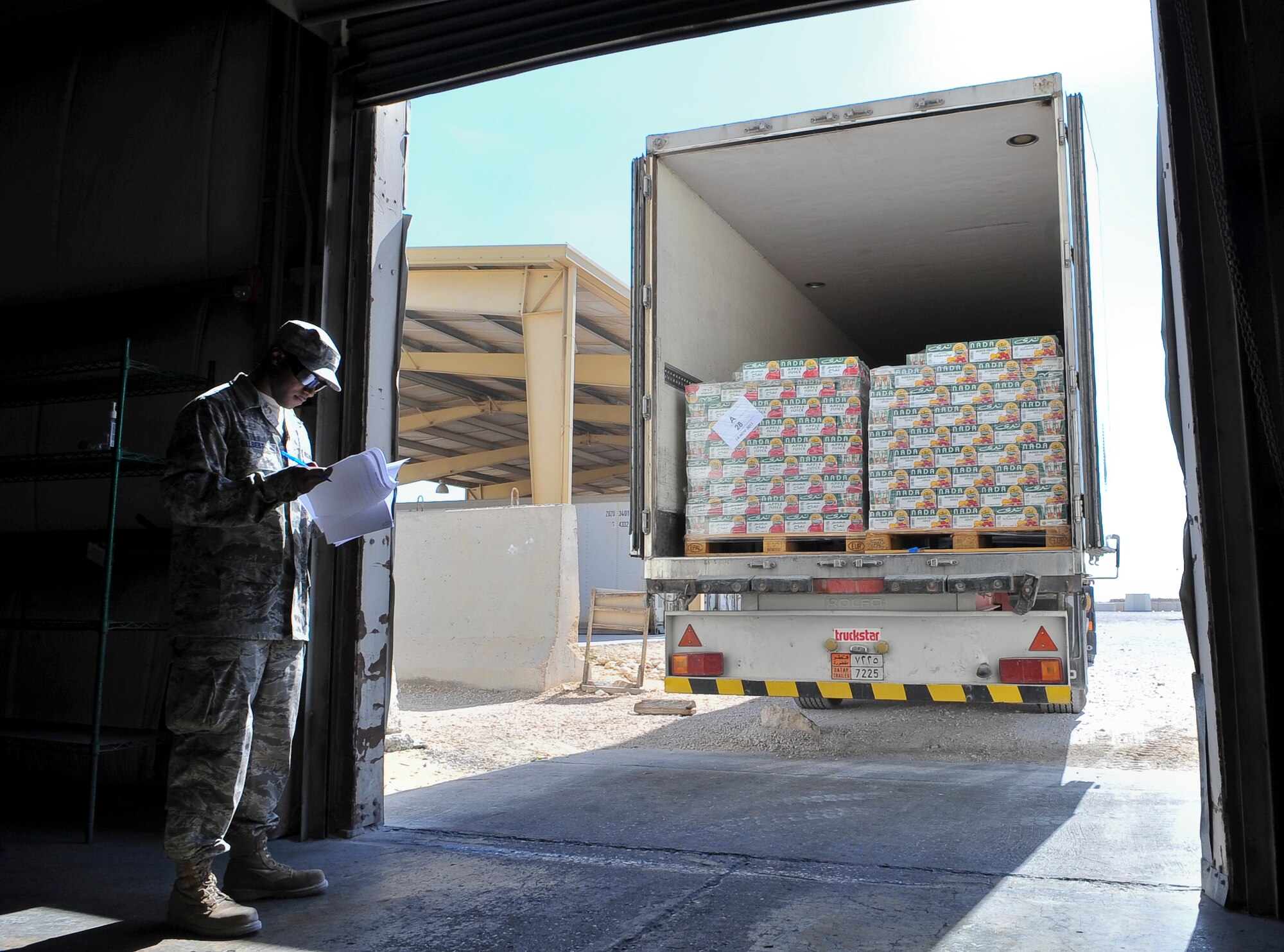 Senior Airman Christopher Gilbert, 379th Expeditionary Force Support Squadron assistant store manager, checks an inventory of items arriving Nov. 11, 2011, for the Thanksgiving Day feast at an undisclosed location in Southwest Asia. Gilbert, a native of Enfield, N.C., is deployed from Yokota Air Base, Japan. (U.S. Air Force photo/Senior Airman Paul Labbe)