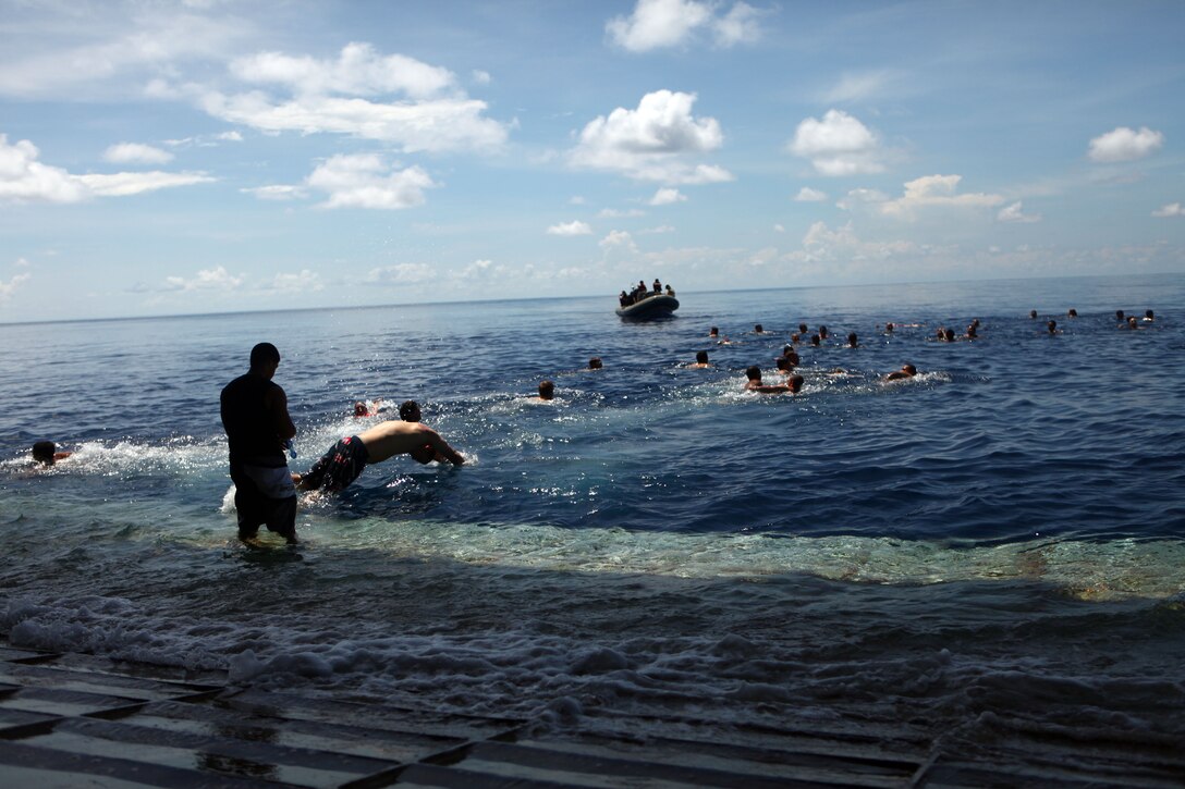 Marines and Sailors with the 31st Marine Expeditionary Unit and the Essex Amphibious Ready Group swim in the ocean at the equator Nov. 25. Marines and Sailors aboard the ship enjoyed a barbeque on the flight deck, and had the opportunity to swim during the steel beach picnic.  The 31st MEU is the only continuously forward-deployed MEU and remains the nation’s force in readiness in the Asia-Pacific region.