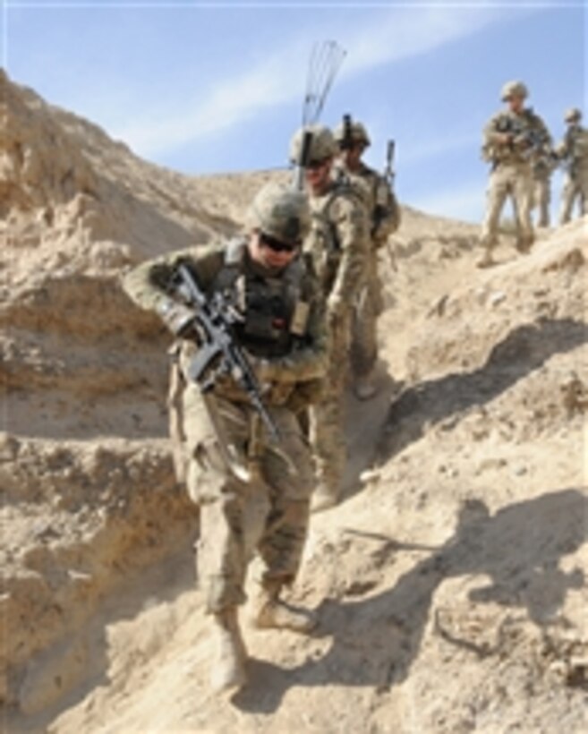 U.S. Army soldiers with the Kandahar Provincial Reconstruction Team security force climb down from their positions during a site assessment of the Dowry Rud check dam in Spin Boldak district, Kandahar, Afghanistan, on Nov. 19, 2011.  
