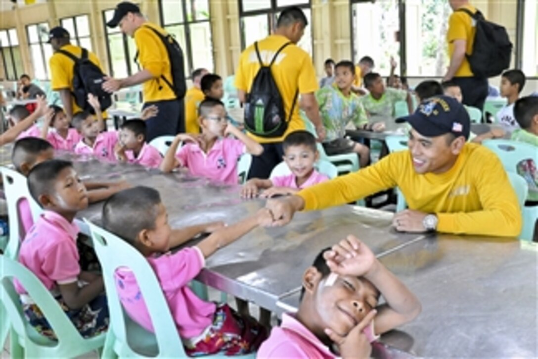 U.S. Navy sailors participate in a community service project at the Banglamung Home for Boys in Pattaya, Thailand, on Nov. 20, 2011.  The sailors are assigned to the guided-missile destroyer USS Lassen (DDG 82), which is assisting disaster relief efforts in Thailand.  