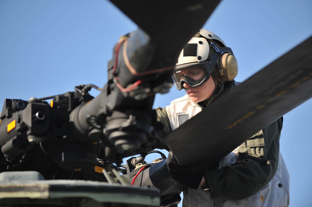 Capt. Karin B. Wareing inspects a CH-46E Sea Knight before flying here Nov. 25. Wareing, a Penacook, N.H., native, serves as a CH-46E Sea Knight pilot with the 11th Marine Expeditionary Units aviation combat element, Medium Marine Helicopter Squadron 268 (Reinforced). The unit embarked USS Makin Island, USS New Orleans and USS Pearl Harbor in San Diego Nov. 14 to begin a seven-month deployment to the Western Pacific and Middle East regions.