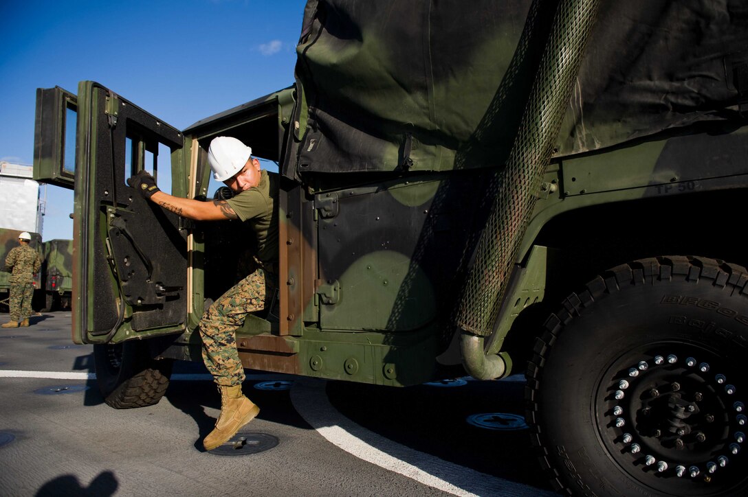 Motor transport operator Lance Cpl. Chris Sanchez backs up a humvee aboard USS Pearl Harbor here Nov. 25. Sanchez, a Turlock, Calif., native, is 20 and serves with Combat Logistics Battalion 11. The battalion is the combat logistics element for the 11th Marine Expeditionary Unit, which embarked USS Makin Island, USS New Orleans and USS Pearl Harbor in San Diego Nov. 14 beginning a seven-month deployment to the Western Pacific and Middle East regions.