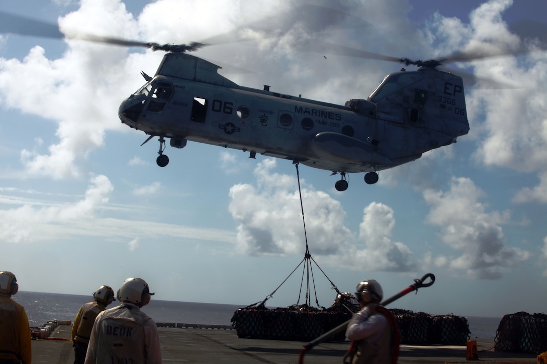 A CH-46E Sea Knight helicopter with Marine Medium Helicopter Squadron 265 (Reinforced), 31st Marine Expeditionary Unit, delivers cargo to the USS Essex (LHD 2), Nov. 26. Marines and Sailors were working together to move cargo aboard the Essex during a resupply at sea. The 31st MEU is the only continuously forward-deployed MEU and remains the nation’s force in readiness in the Asia-Pacific region.