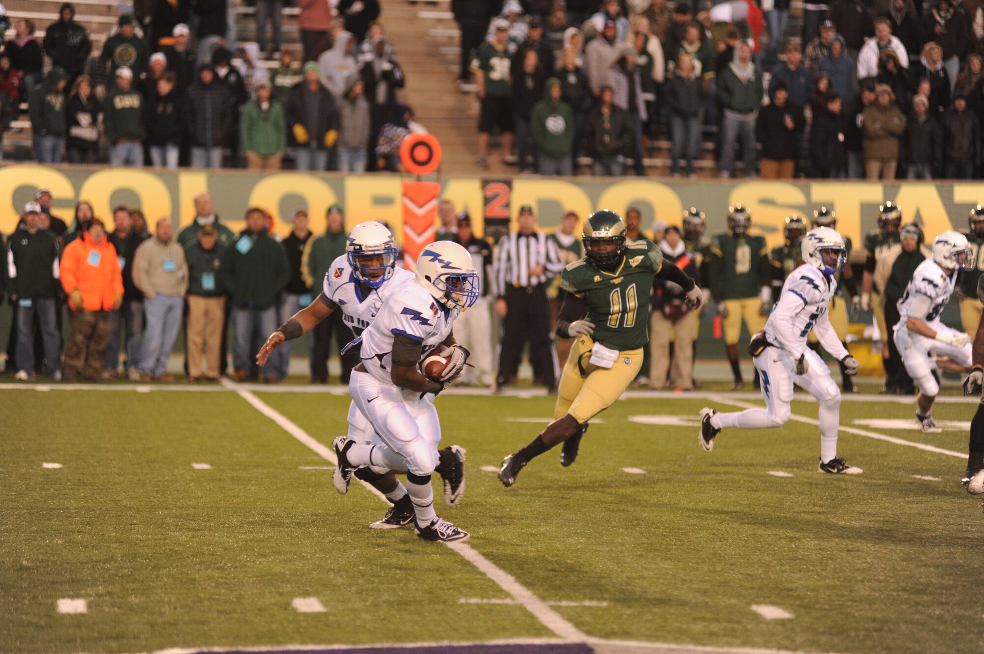 Air Force quarterback Tim Jefferson hands off to running back Asher Clark.  The pair of seniors led the Falcons’ rushing game, that ran 49 times for 344 yards and three touchdowns, as the Air Force Academy beat CSU 45-21.  This win closes out the Falcons’ regular season record at 7-5, making the team eligible for a bowl game. (U.S. Air Force Photo/ John Van Winkle)