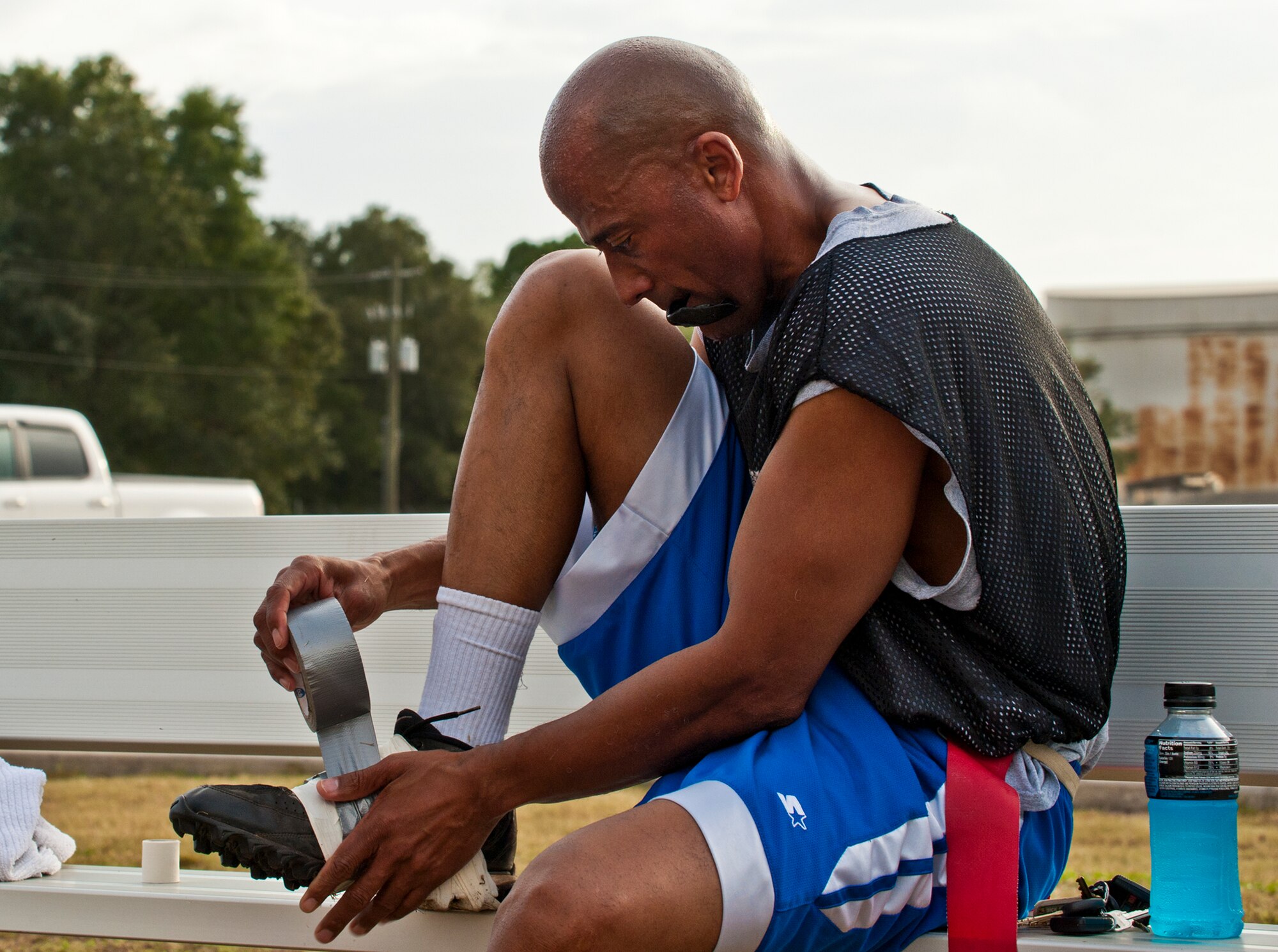 Eagles’ quarterback, Tony Douglas, tapes up his shoe to continue during half-time at the annual Chiefs versus Eagles football game Nov. 22 at Eglin Air Force Base, Fla.  The Eagles avenged last year’s defeat by dominating the Chiefs 35-13.  (U.S. Air Force photo/Samuel King Jr.)