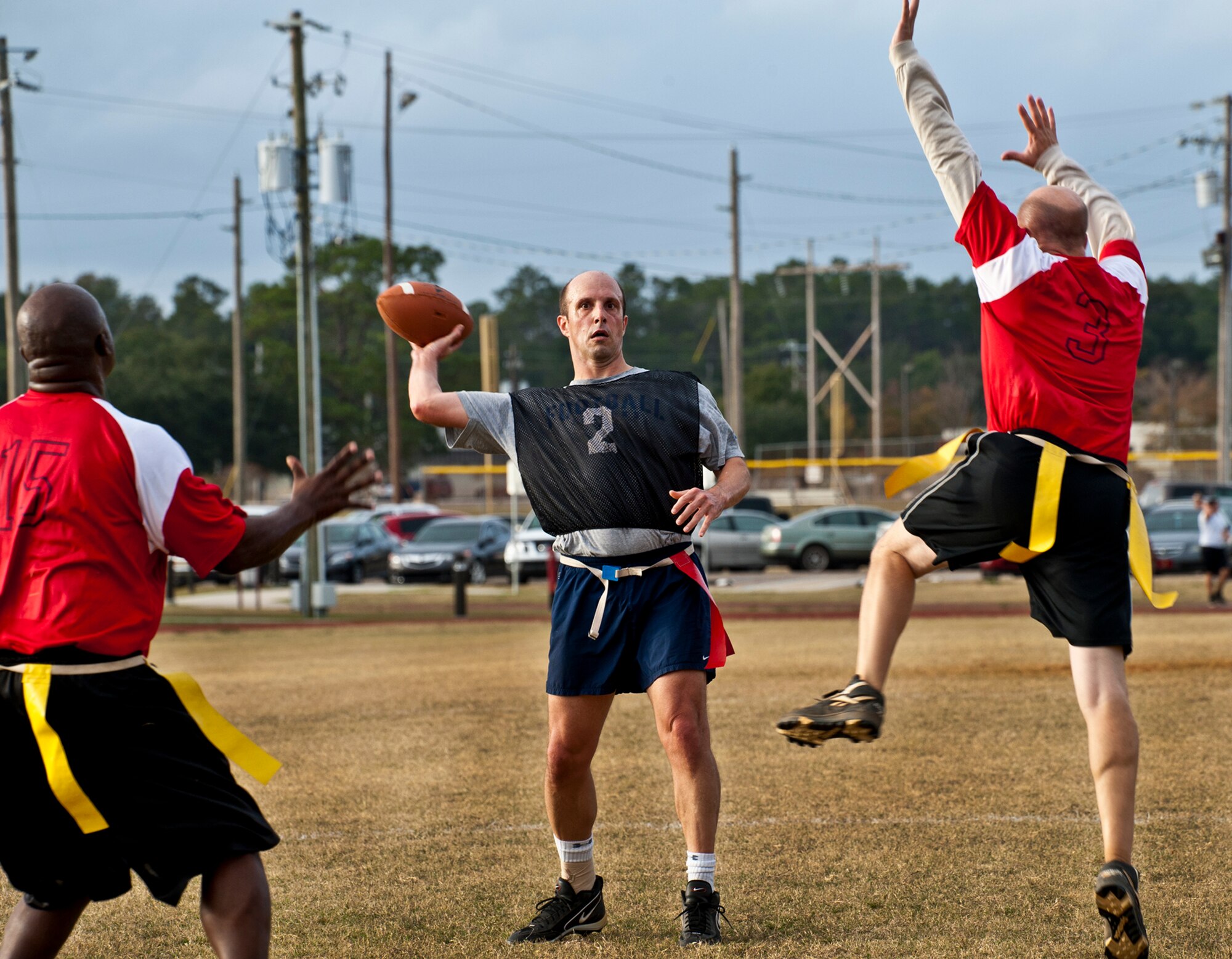 Michael Contratto threads a pass between two Chief defenders during the annual Chiefs versus Eagles football game Nov. 22 at Eglin Air Force Base, Fla.  The Eagles avenged last year’s defeat by dominating the Chiefs 35-13.  (U.S. Air Force photo/Samuel King Jr.)